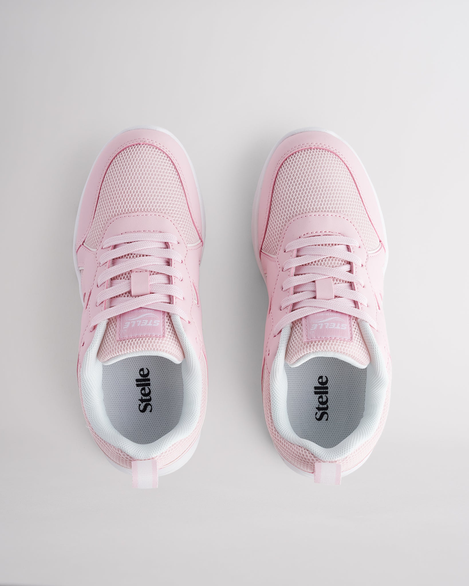 Pink lightweight kids’ sneakers with breathable mesh uppers, a cushioned insole, and a durable outsole.