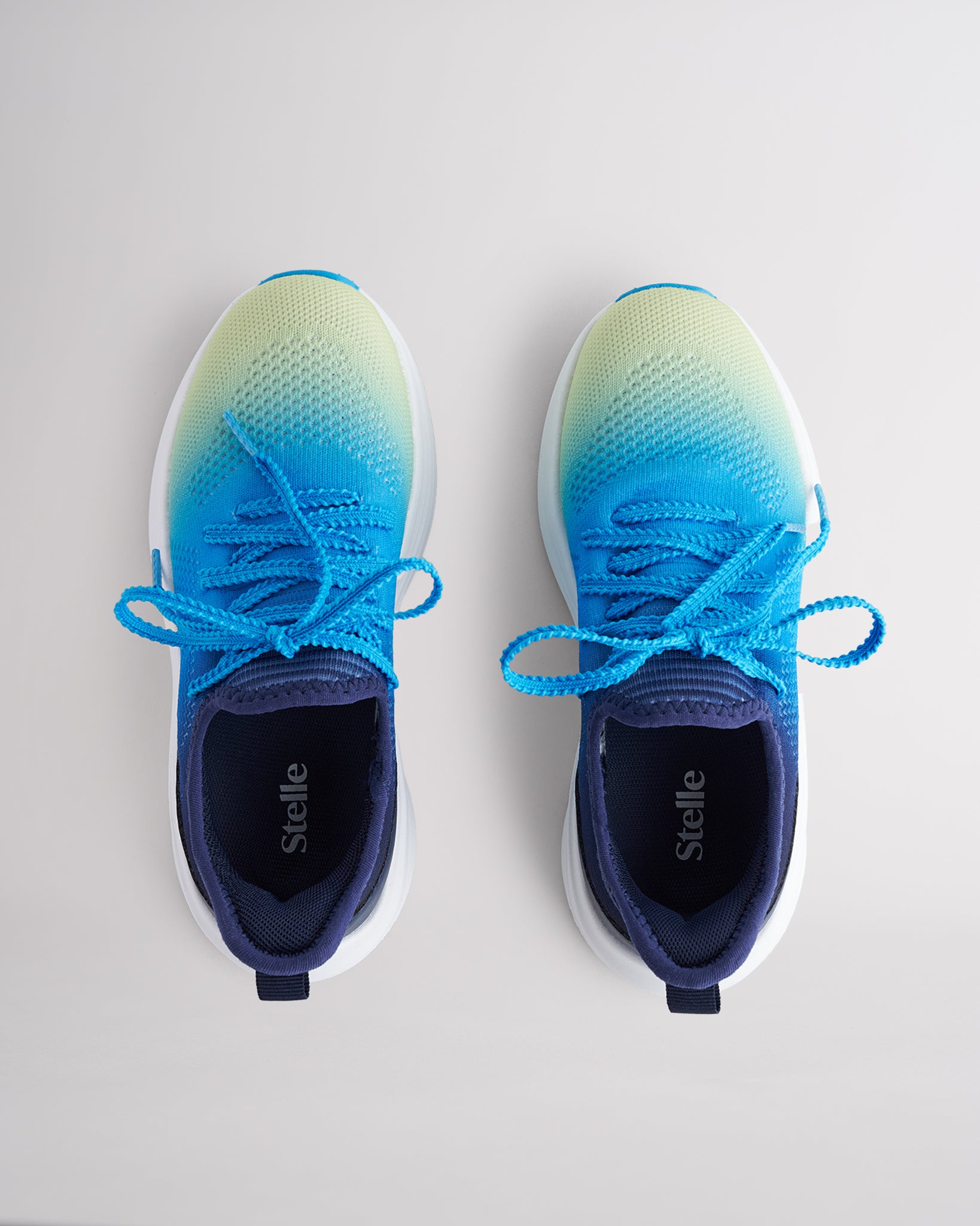 Kids Lume Lagoon lace-up running sneakers with cushioned white sole.