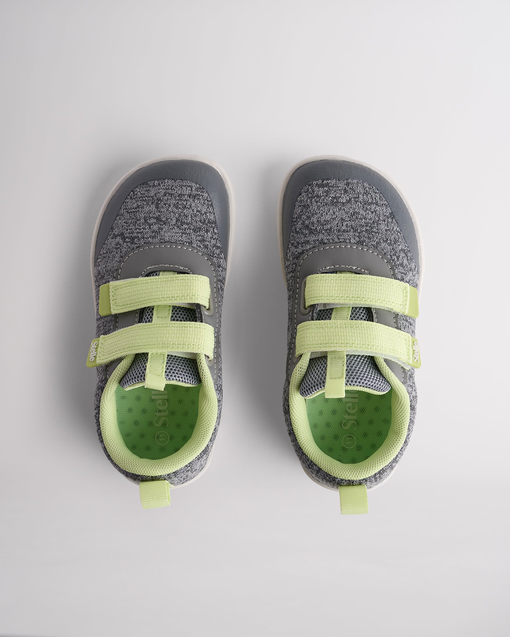 Top view of grey kids barefoot shoes showing dual straps and breathable interior