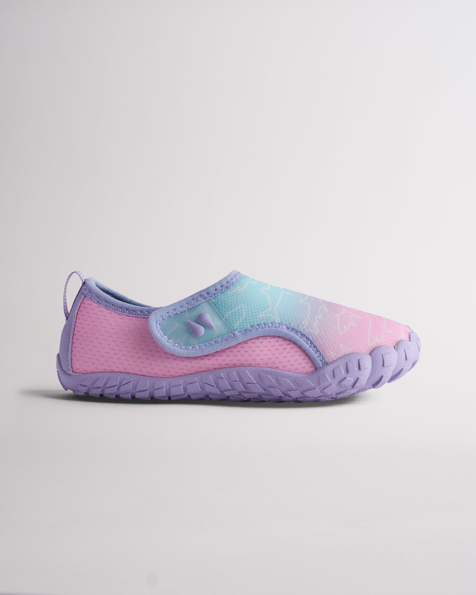 Side view of Kids StelleMesh slip-on water shoe with pastel mermaid ombre upper, wide velcro closure, and purple traction outsole.