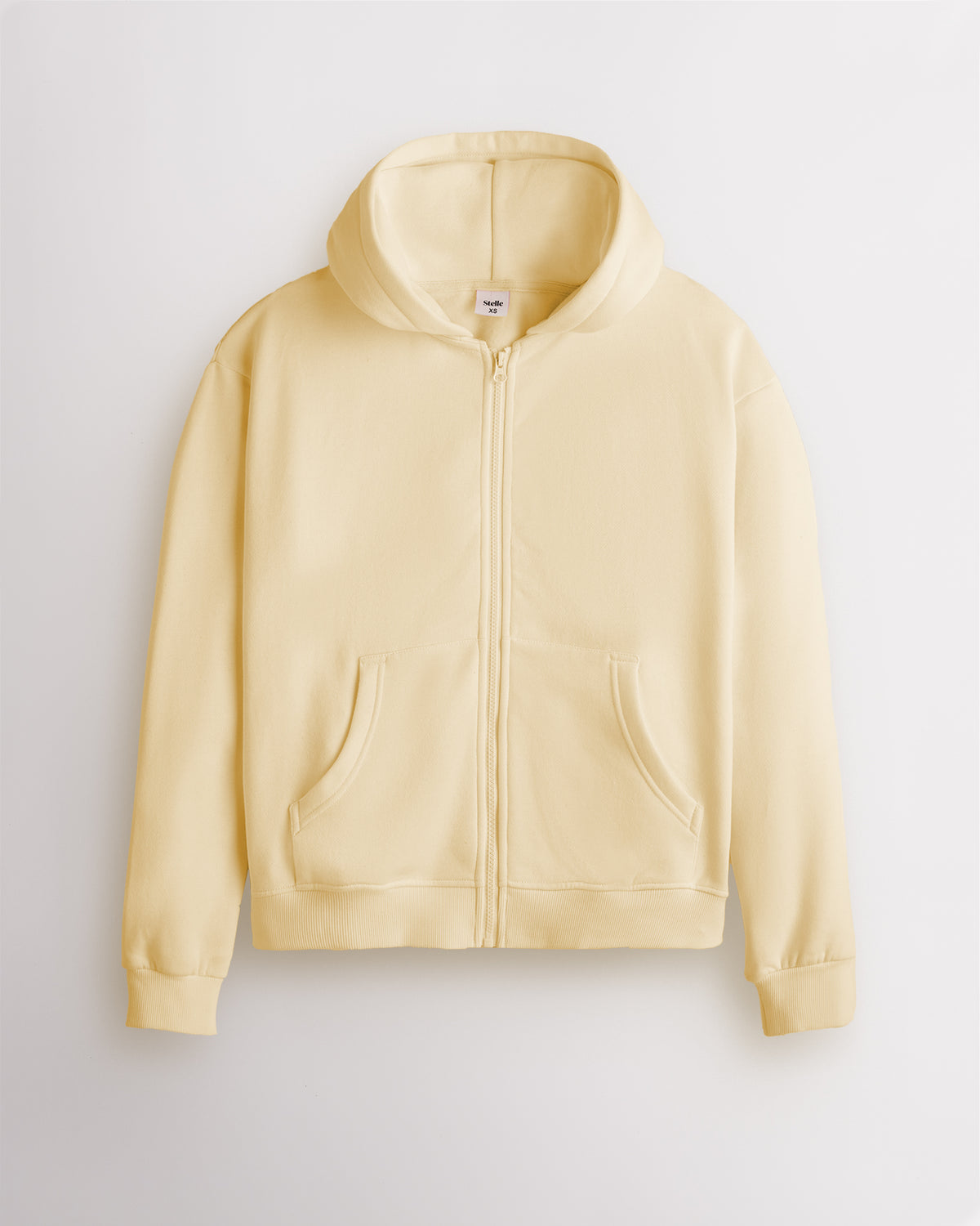 Butter yellow Stelle women's fleece-lined zip-up hoodie shown flat, front view with the zip closed.