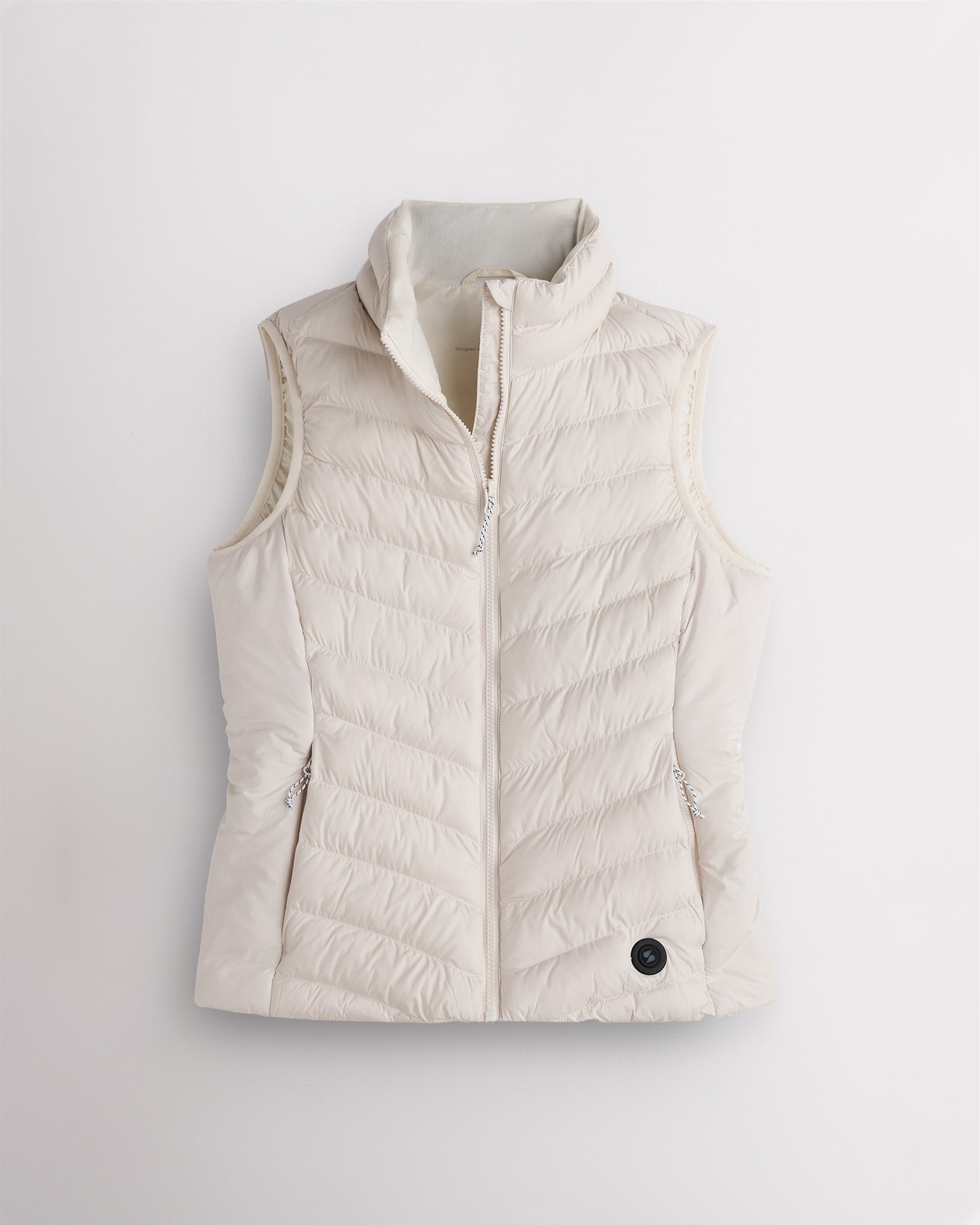 Beige puffer vest on a light gray background