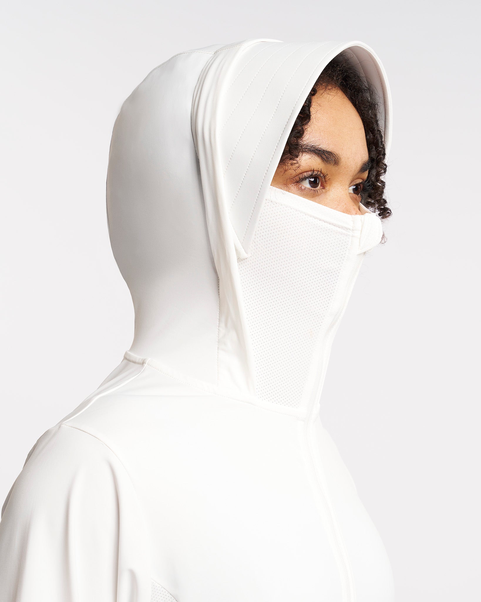 Close-up of UV-protective jacket hood with built-in mesh face cover and wide brim for sun protection.