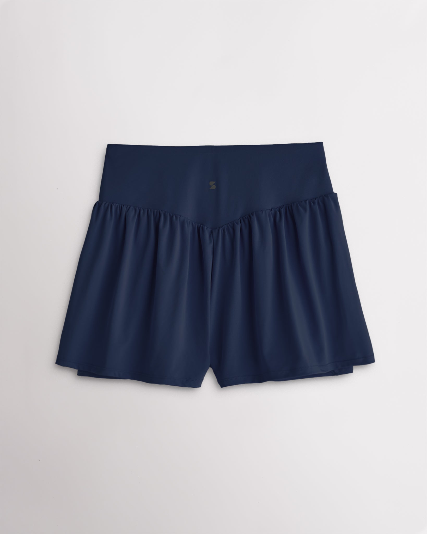 Back view of women’s navy high waisted athletic shorts with a flowy layered design and V-contour back seam.