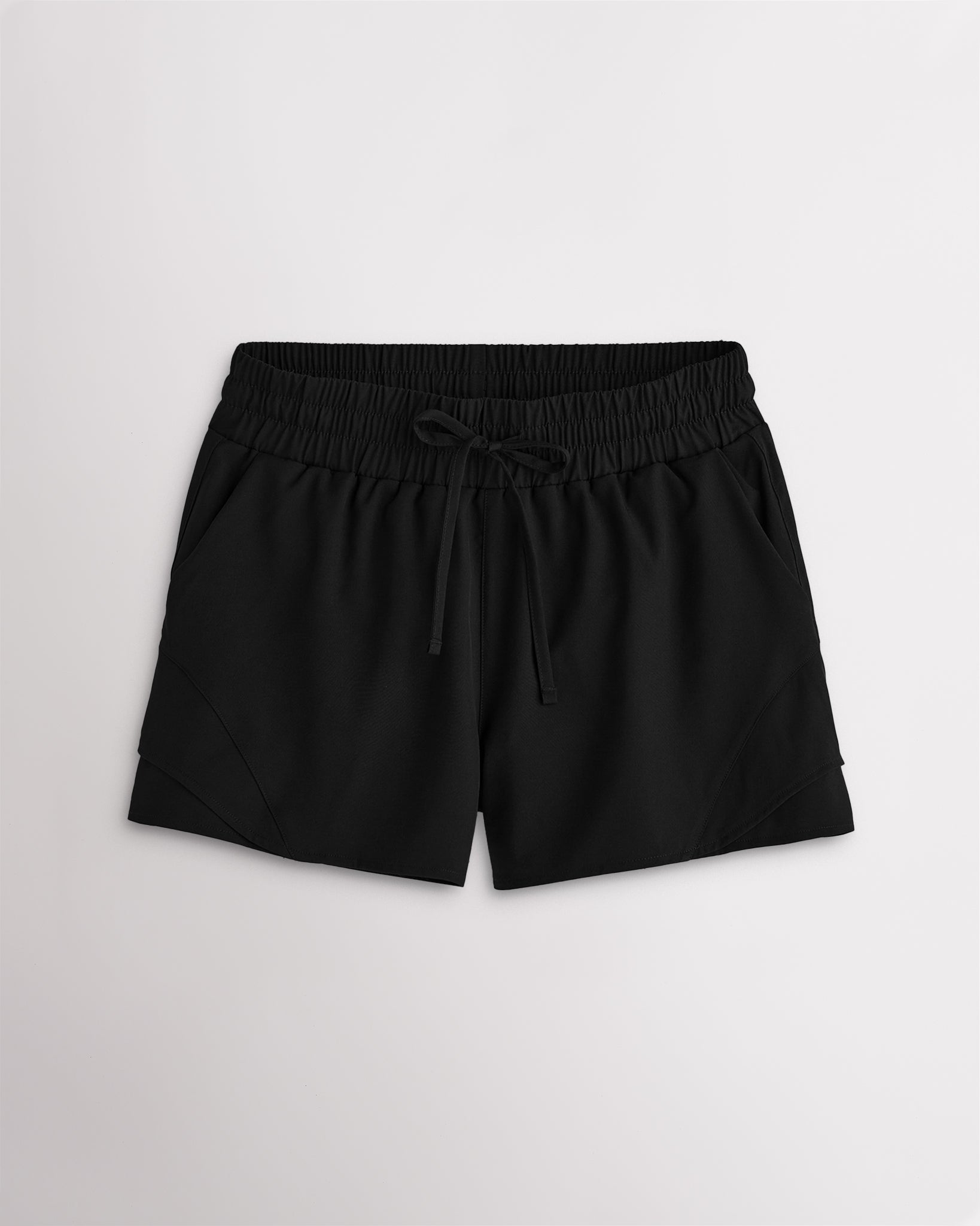 Women’s black high-rise running shorts with a wide elastic waistband, drawstring tie, side pockets, and double-layer hem.