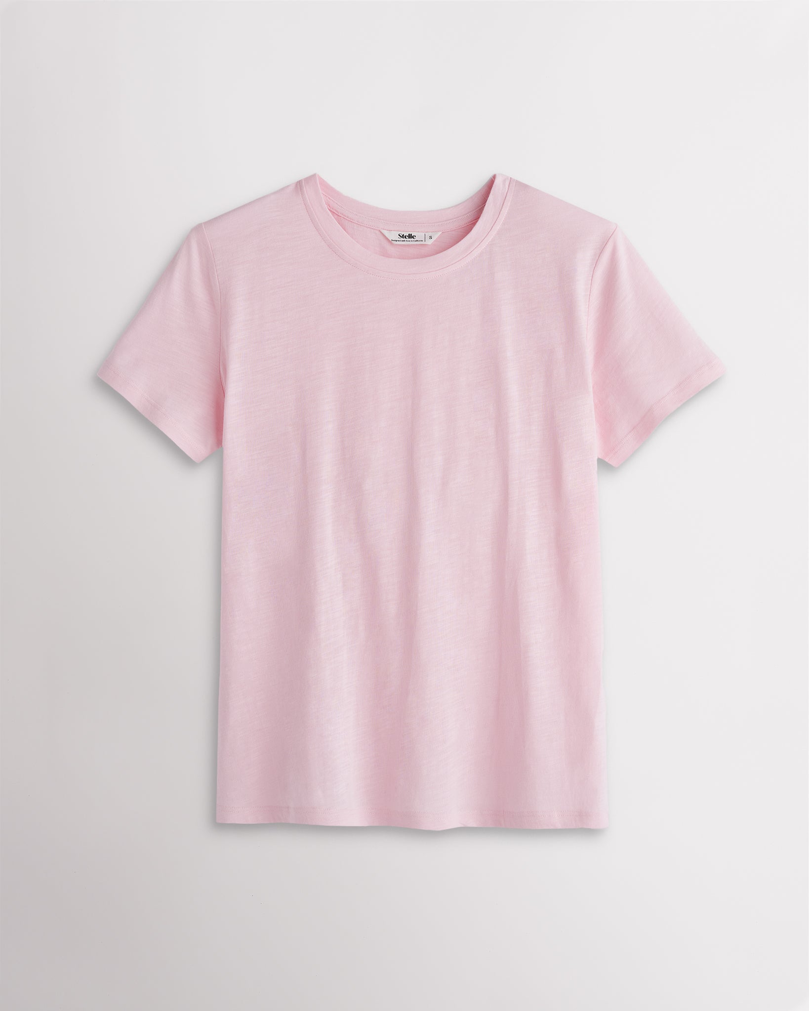 Women’s light pink classic short sleeve crewneck T-shirt with a relaxed fit, soft drape, and clean everyday silhouette.
