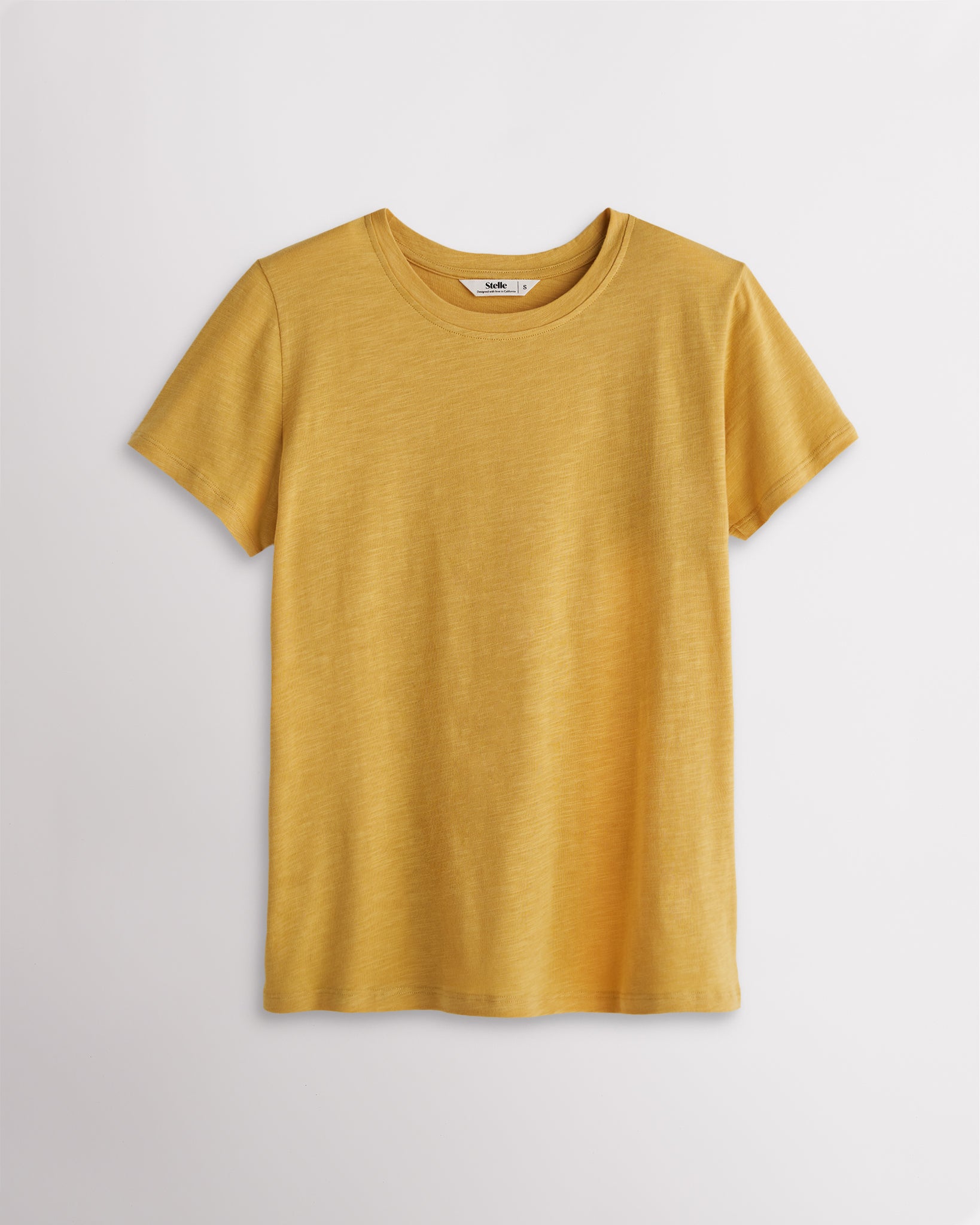 Women’s mustard classic short sleeve crewneck T-shirt with a relaxed fit, soft drape, and clean everyday silhouette.