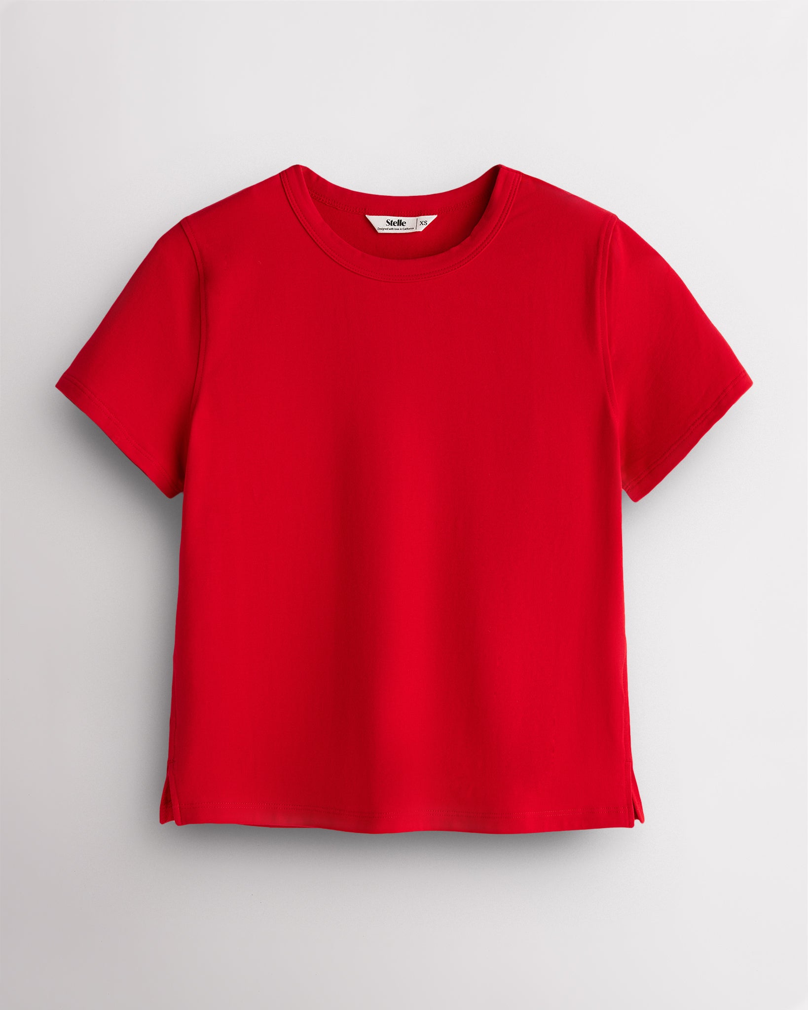 Red Stelle womens short sleeve basic t shirt with crewneck, relaxed boxy fit, and side slits on white background
