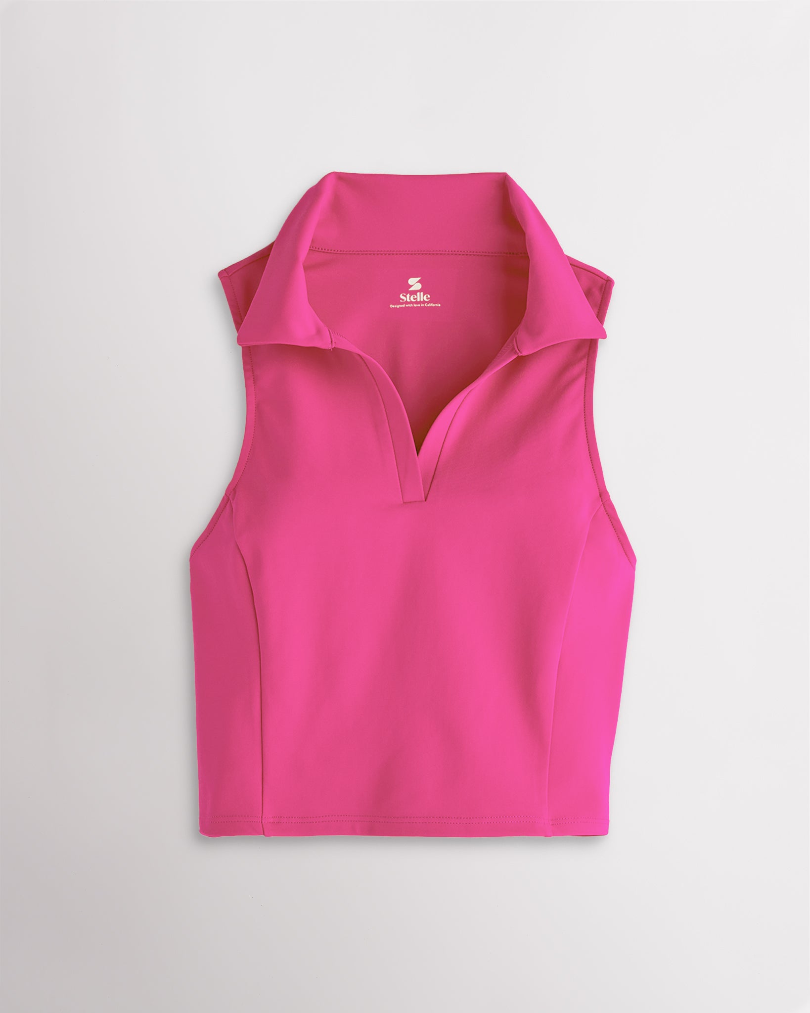 Dreamhouse Pink Stelle V-neck fitted cropped polo tank top with classic collar and princess seams, styled as a womens summer top.