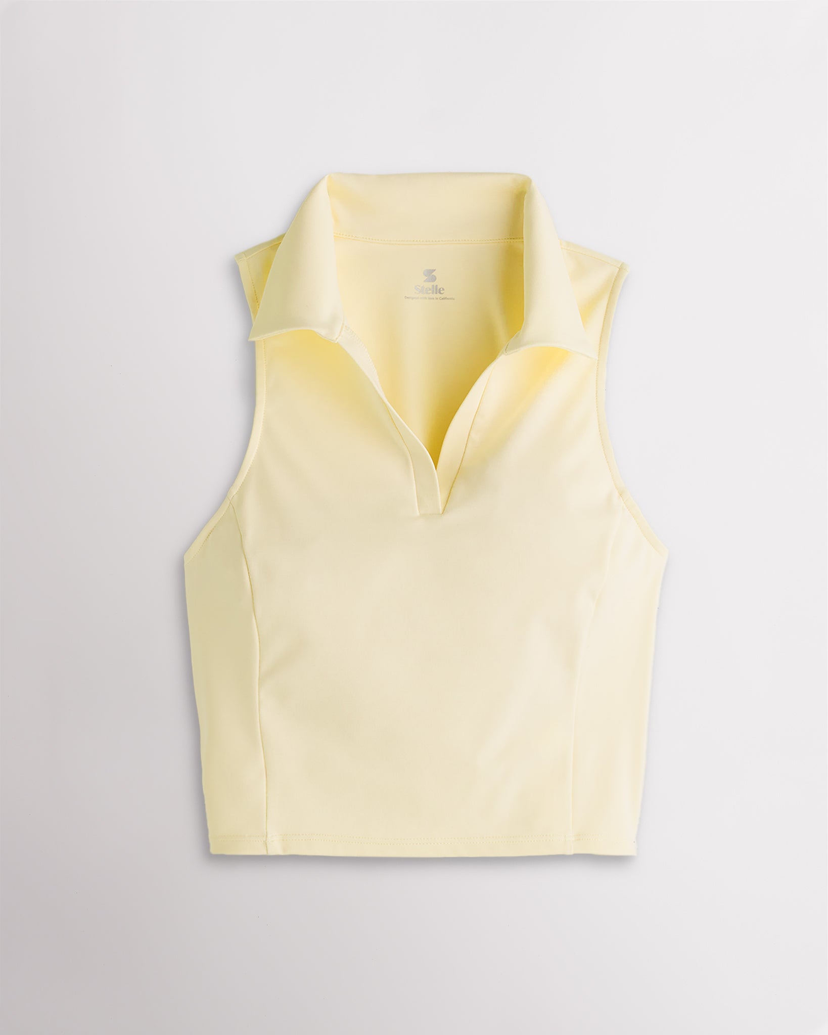 Lemon butter Stelle V-neck fitted cropped polo tank top with classic collar and sculpted princess seams for womens summer wear.