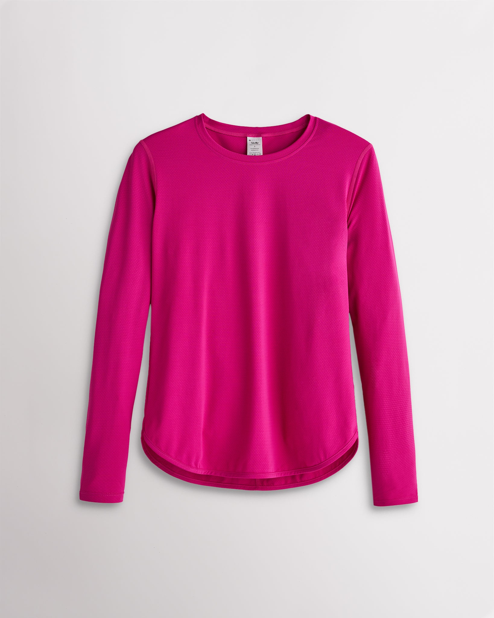 Women’s fuchsia UPF 50+ long sleeve sun protection shirt with curved hem and lightweight breathable fabric.