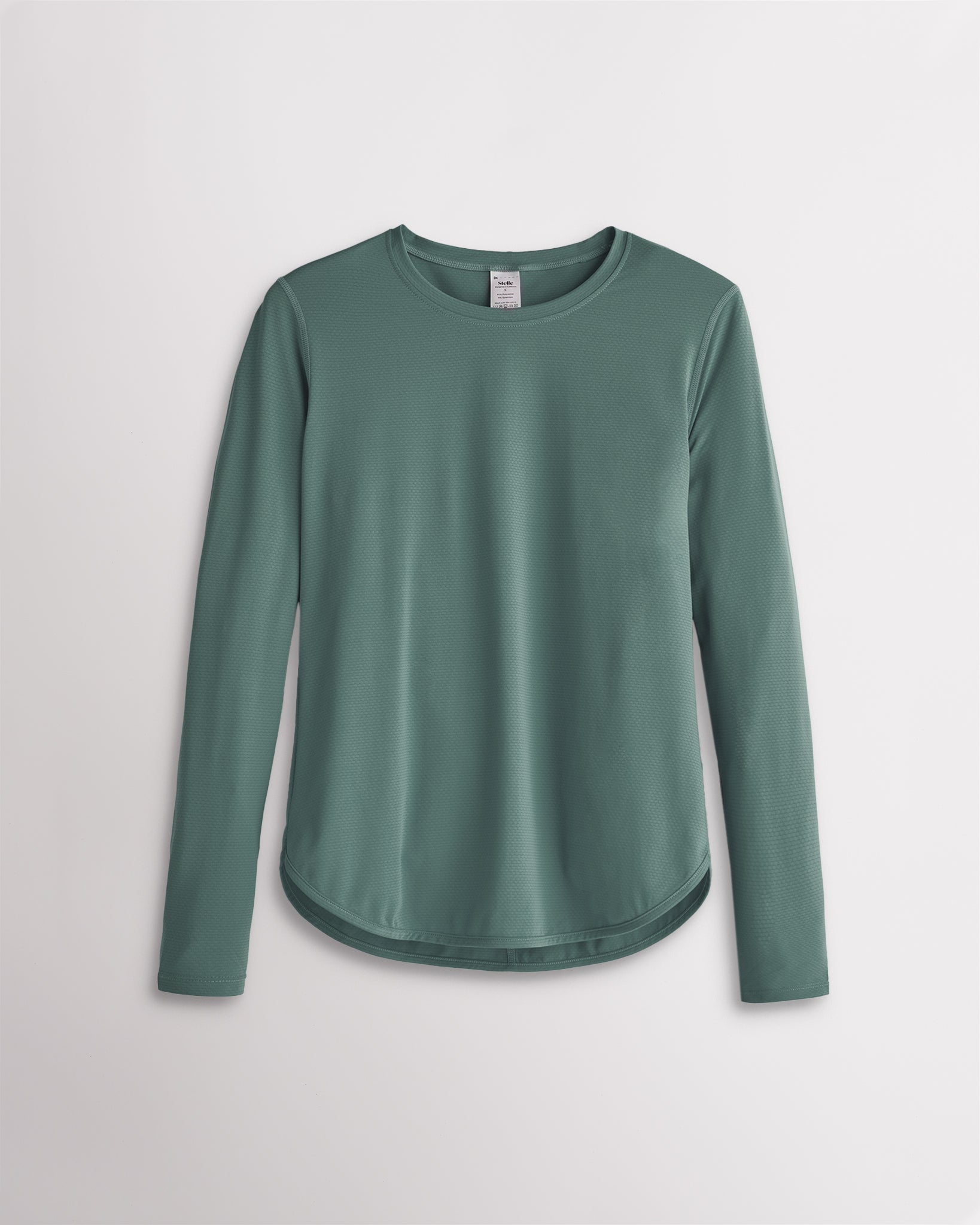Women’s sage green UPF 50+ long sleeve sun protection shirt with curved hem and lightweight breathable fabric.