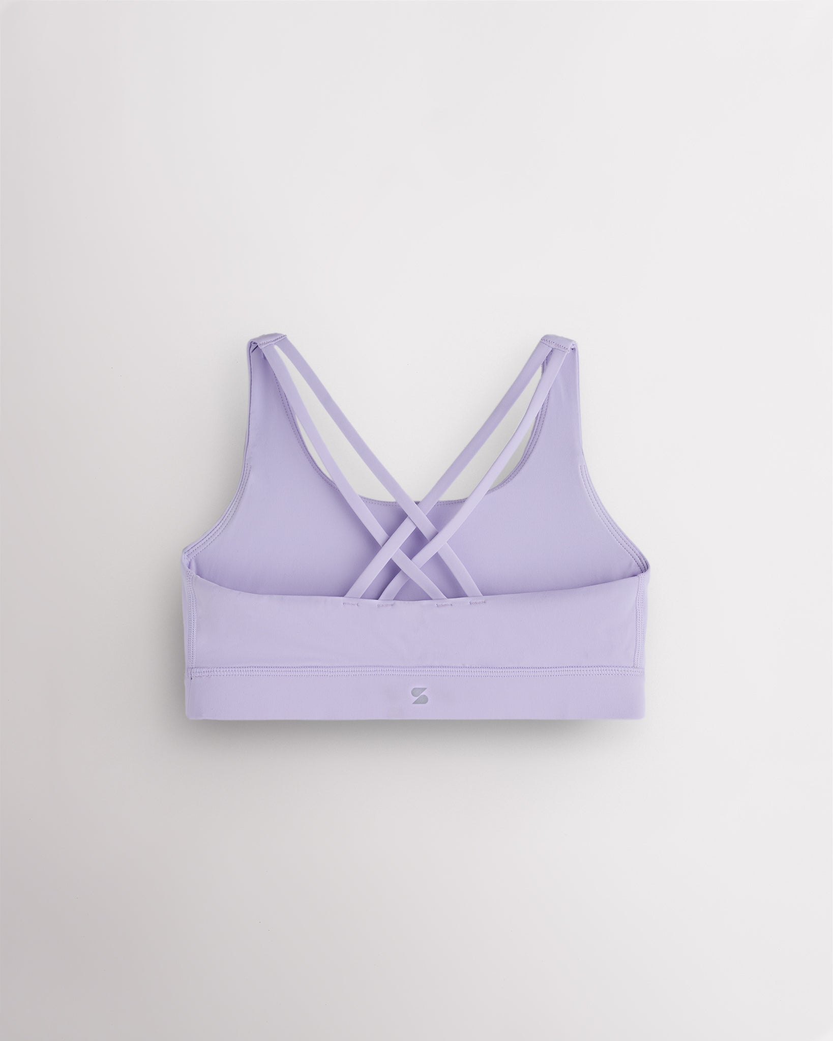 Back view of a girls lavender sports bra featuring multiple criss-cross straps and a wide supportive band.
