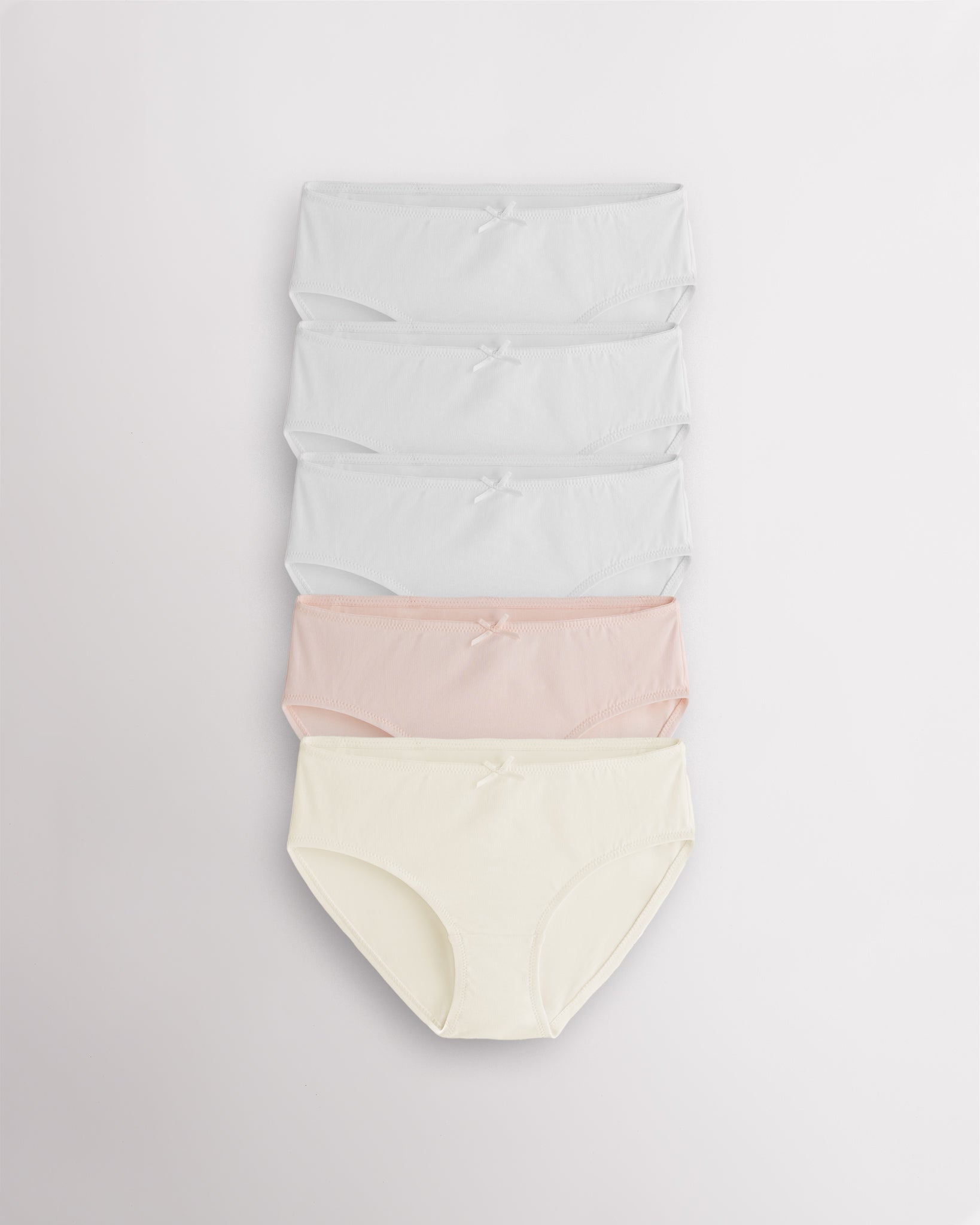 White and pastel girls briefs set with soft cotton fabric, front bow accents, lined gusset, and everyday comfort design.