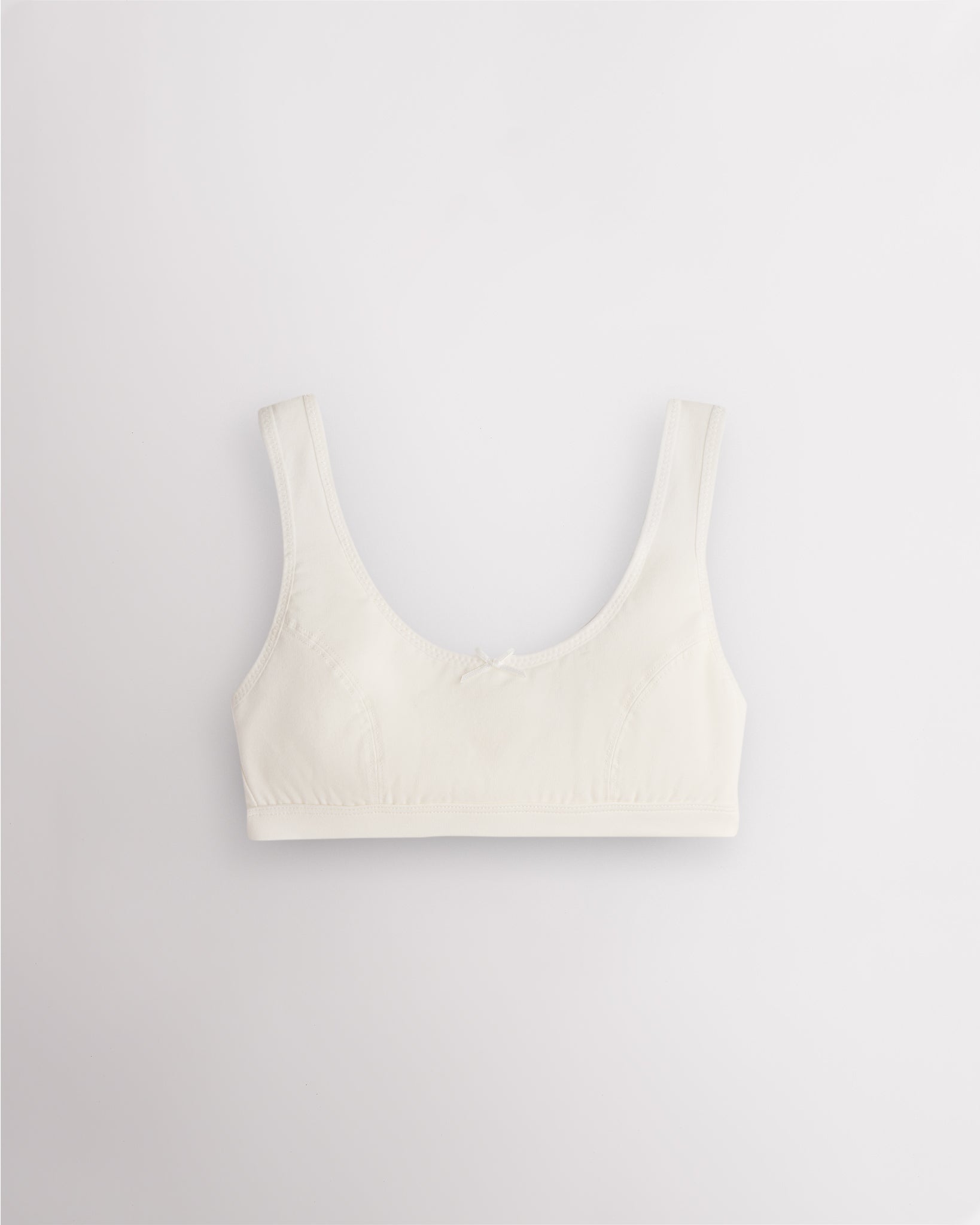 Stelle girls cotton bralette in white with wide straps, soft lining, and fixed padding for everyday wear