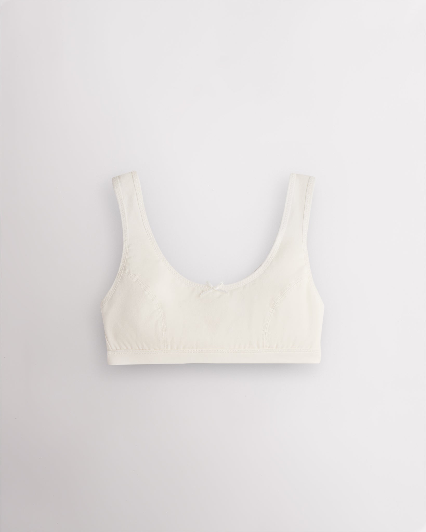 Stelle girls cotton bralette in white with wide straps, soft lining, and fixed padding for everyday wear