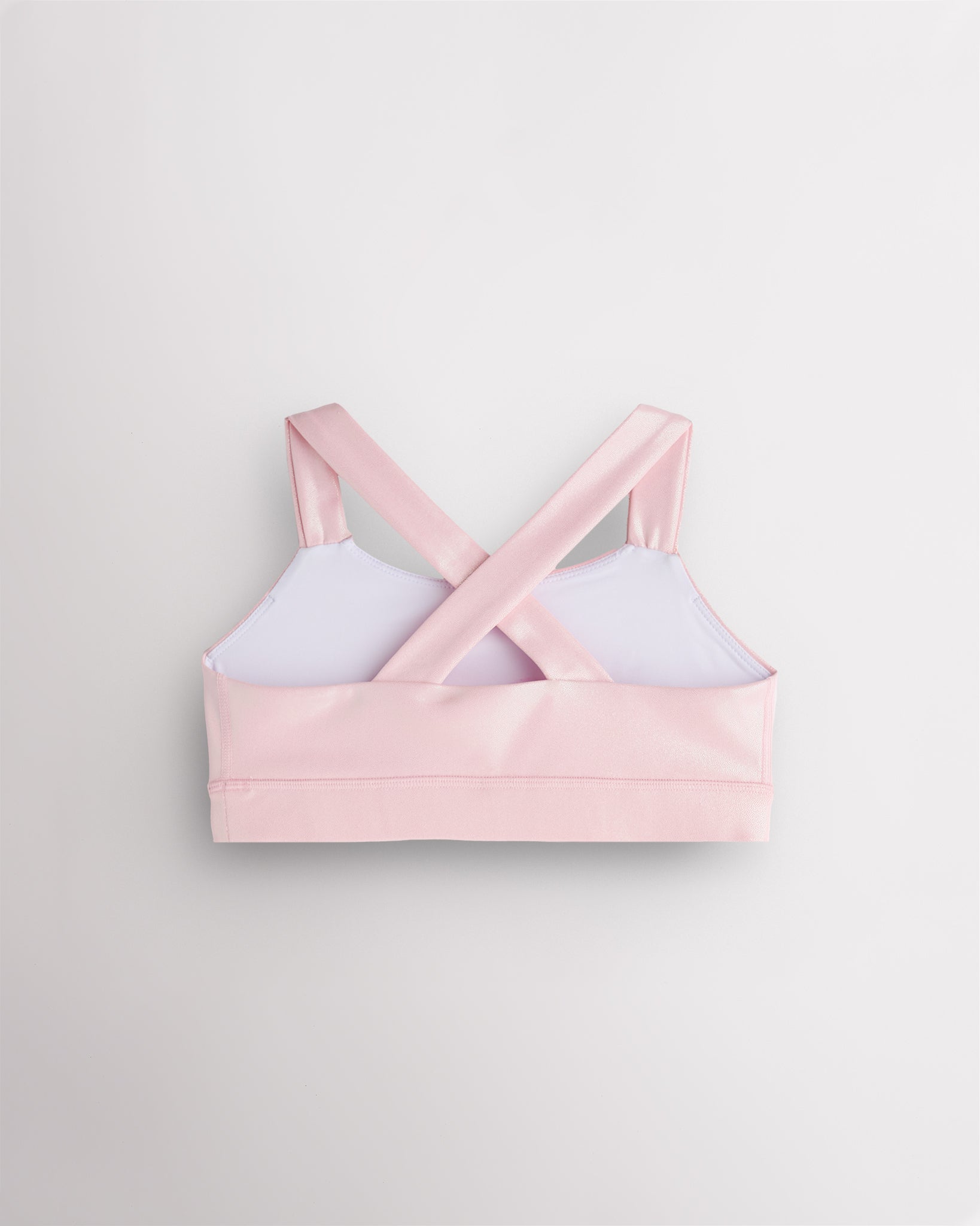 Back view of pink metallic dance top with criss-cross racerback straps and a supportive band.