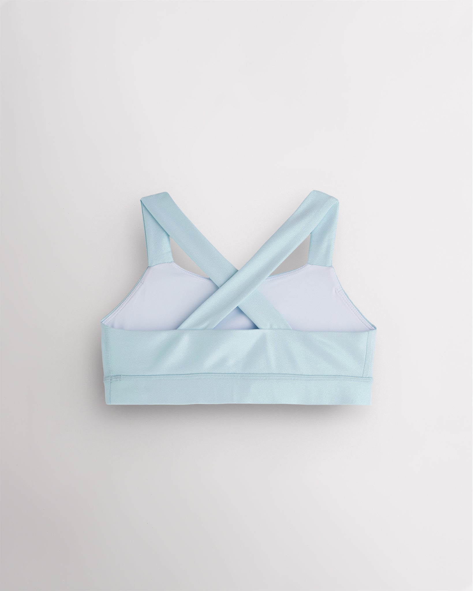 Back view of light blue metallic dance top with criss-cross racerback straps and a supportive band.