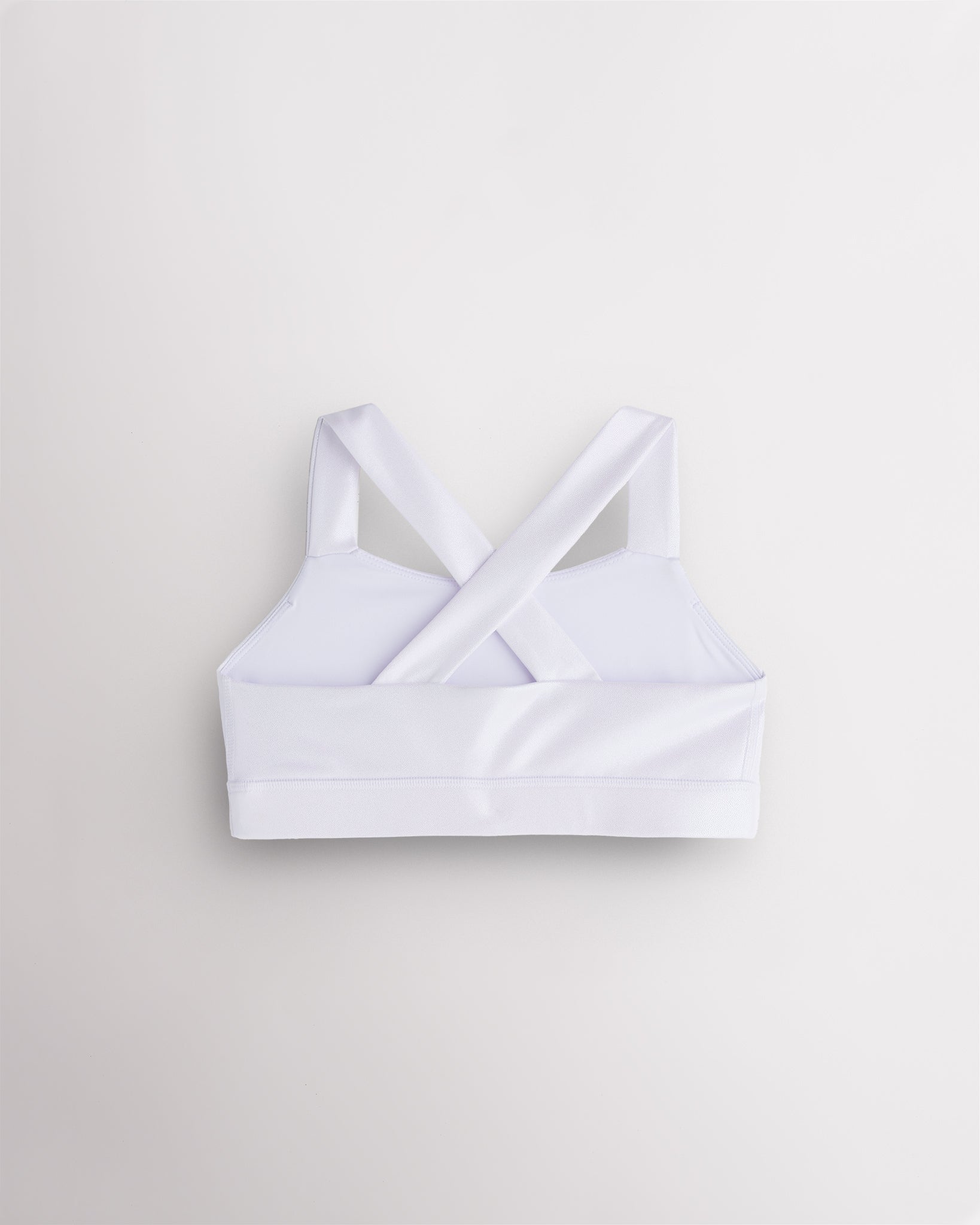Back view of white metallic dance top with criss-cross racerback straps and a supportive band.