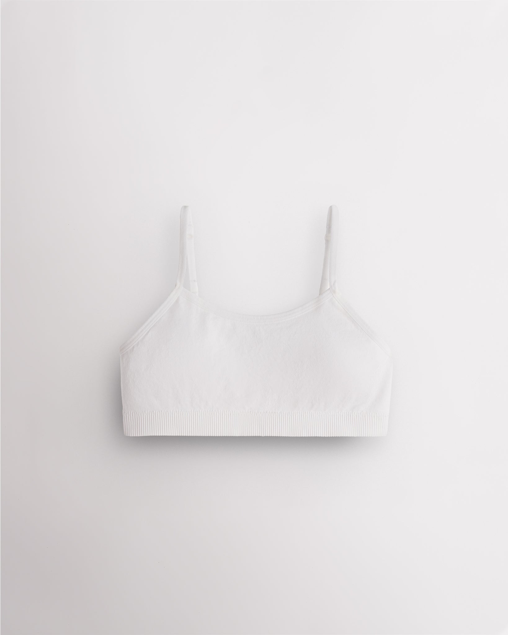 White Stelle girls seamless cami bra with slim adjustable straps and soft ribbed support band.