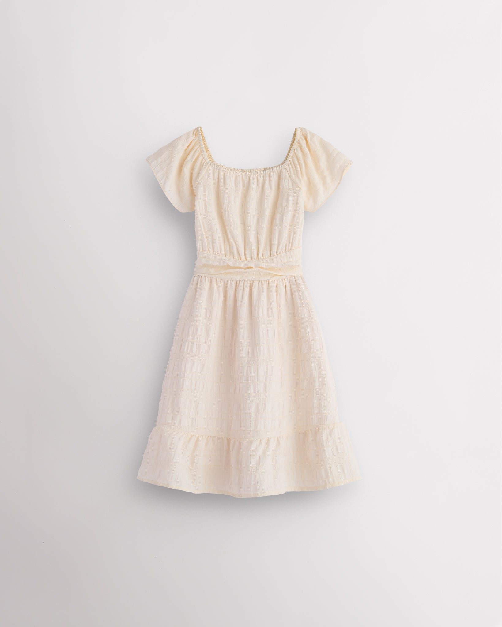 Butter girls smocked summer dress with short sleeves, square neck, fit-and-flare shape, and ruffle hem.