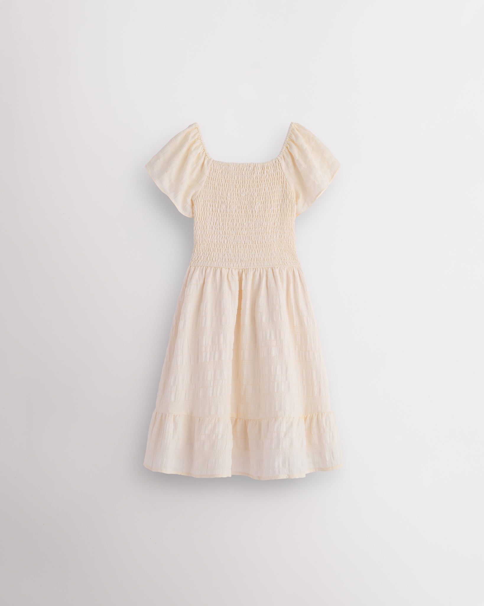 Back view of butter girls summer dress showing smocked back, short sleeves, and soft gathered skirt.