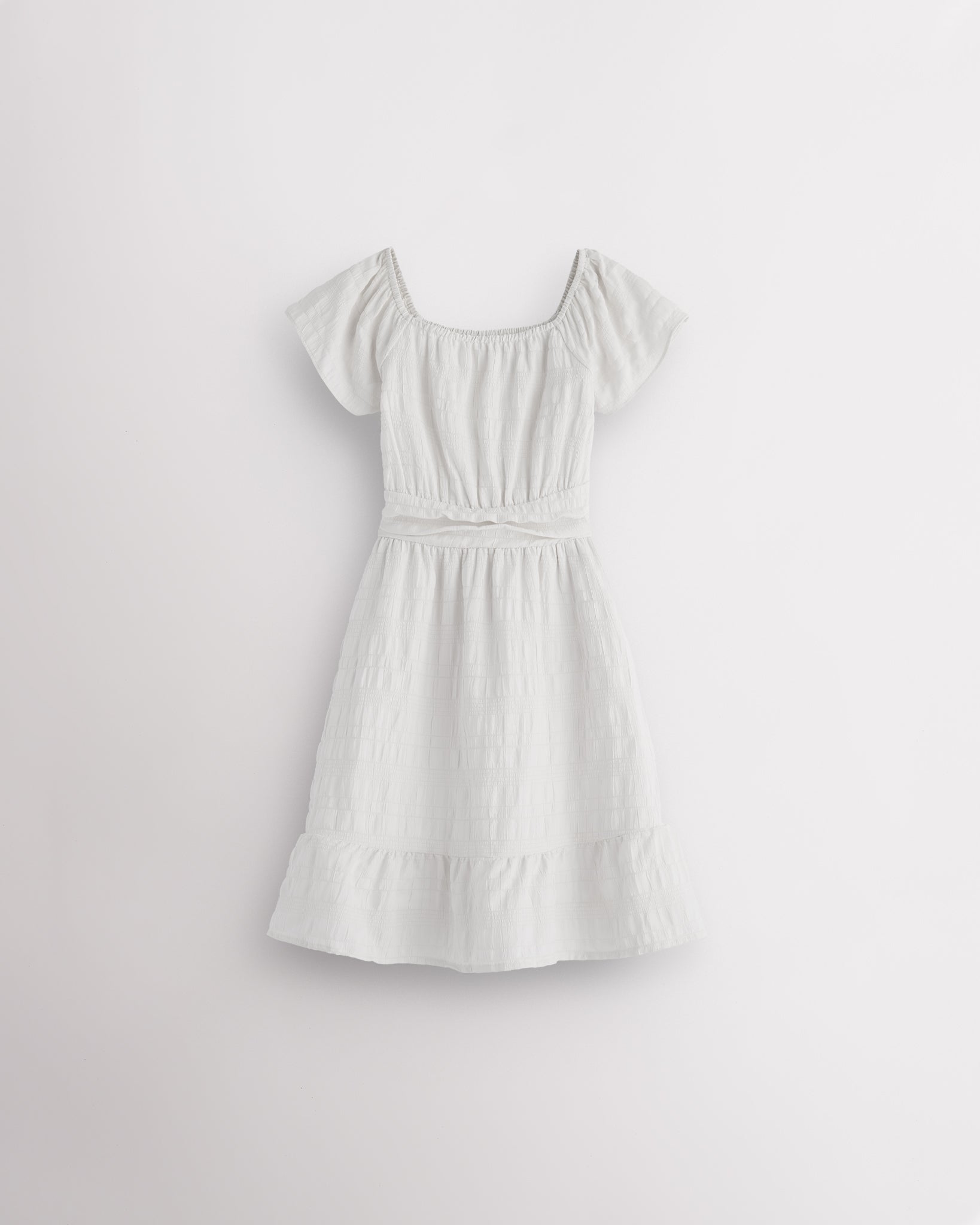 White girls smocked summer dress with short sleeves, square neck, fit-and-flare shape, and ruffle hem.