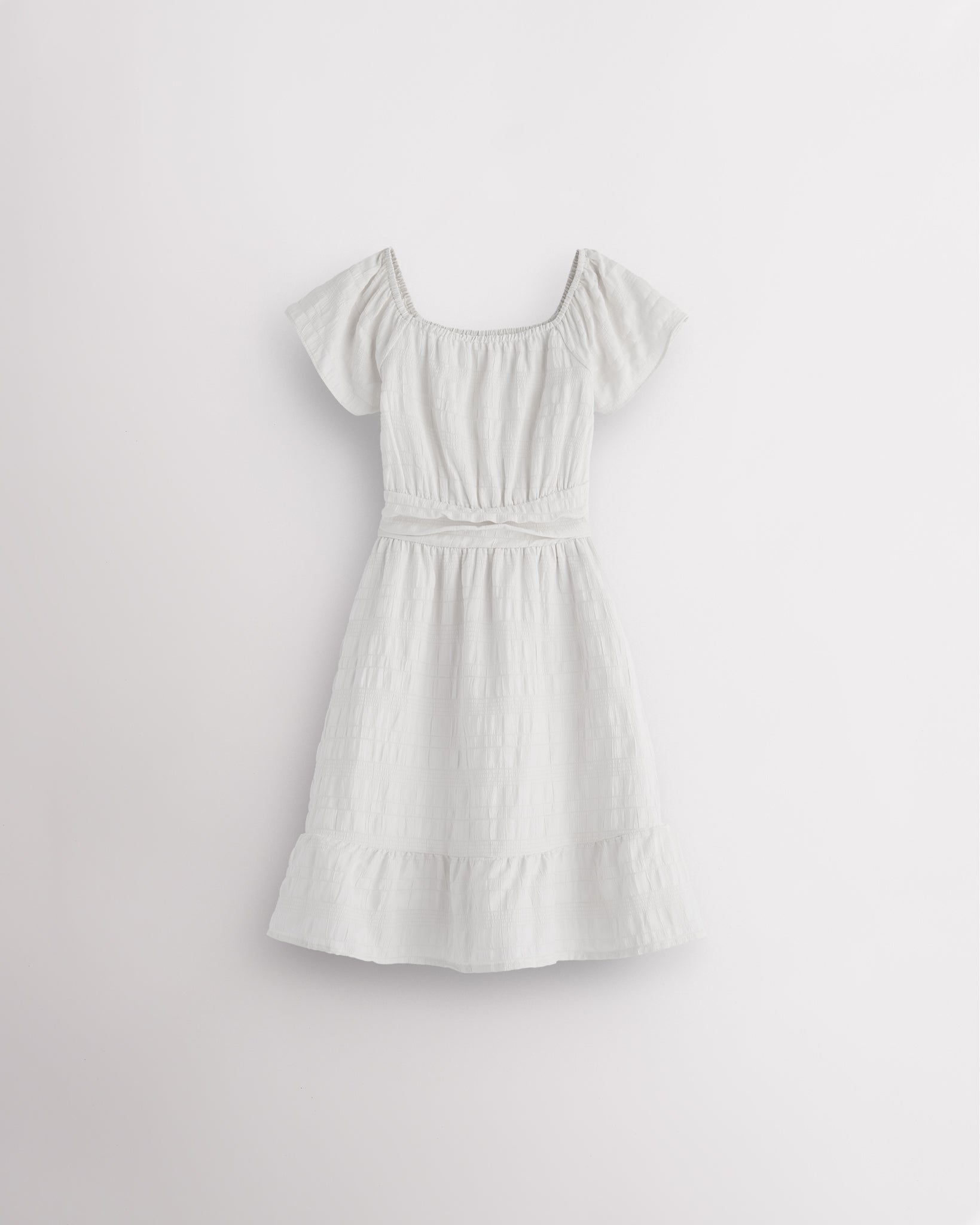 White girls smocked summer dress with short sleeves, square neck, fit-and-flare shape, and ruffle hem.