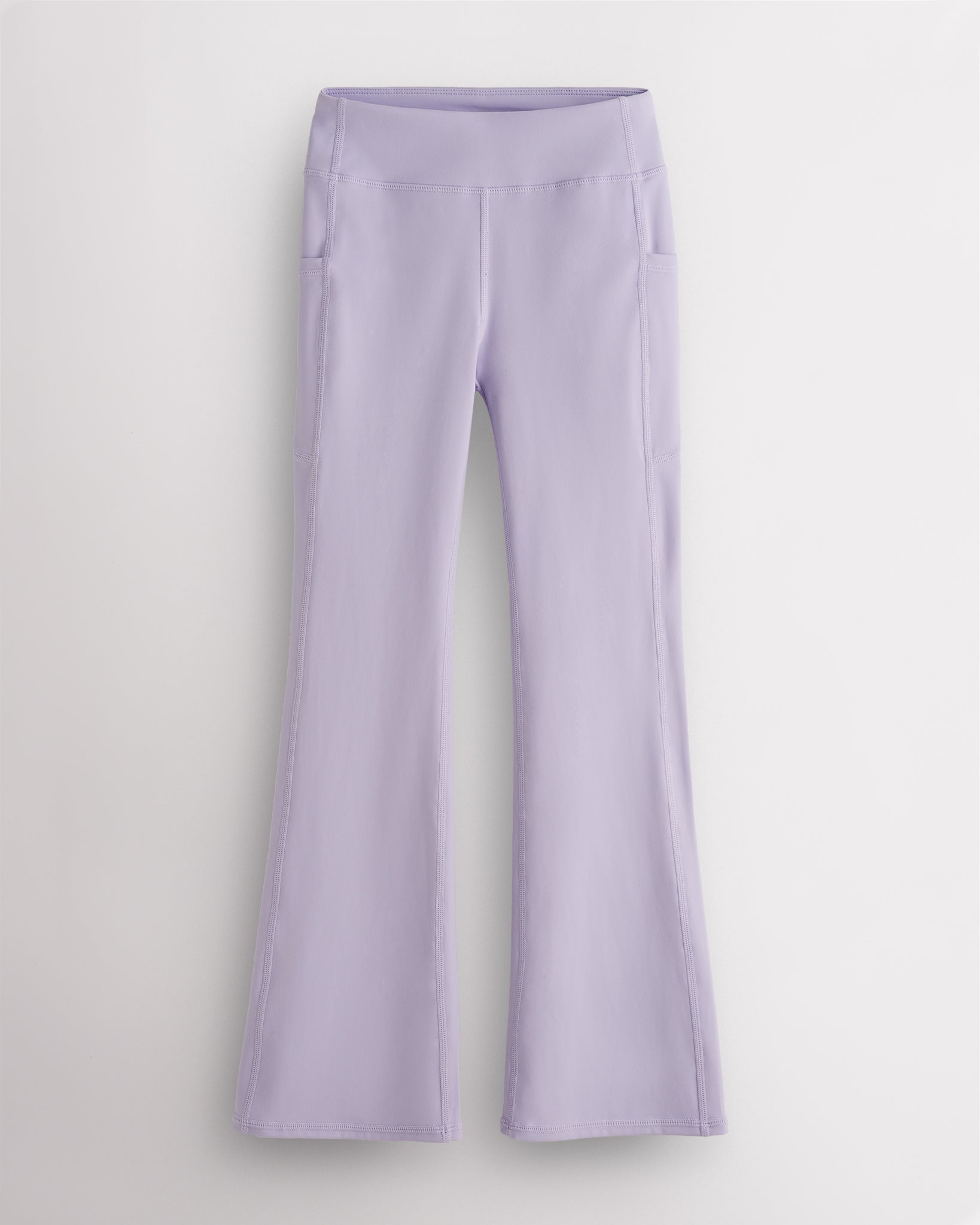 Lavender girls flare leggings with high waist, side pockets, sleek waistband, and flared hem for activewear and everyday movement.