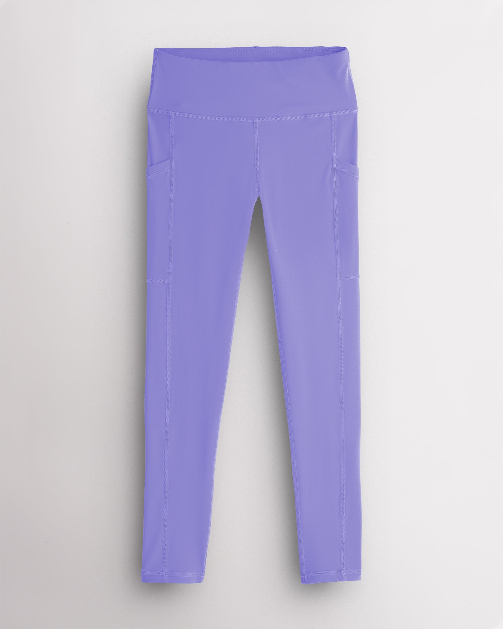 Periwinkle girls athletic leggings with side pockets, a wide supportive waistband, and soft stretch fabric for active and casual wear.