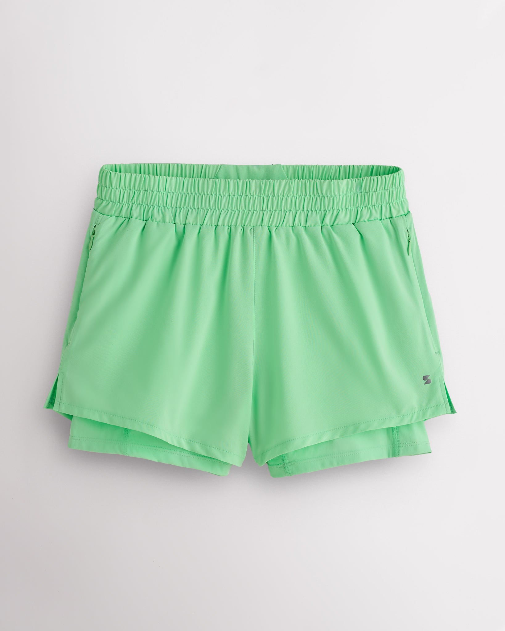 Neon Green Stelle women’s 2-in-1 running shorts with elastic waistband, zipper pockets, inner shorts liner, and curved side hems.