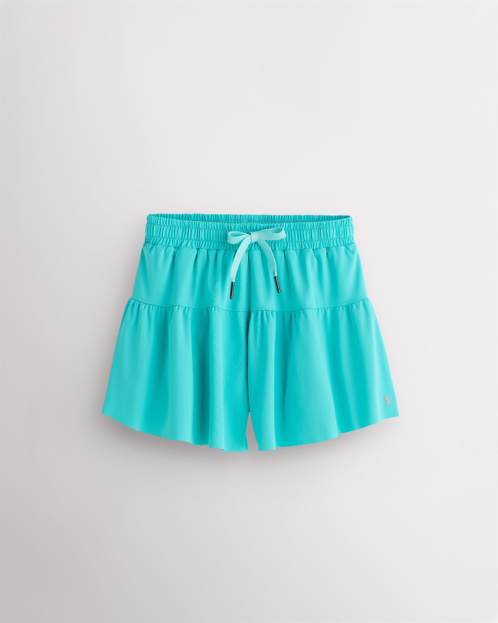 Aqua blue Kids Let’s Bounce Shorts with flowy design, elastic waistband, drawstring, lightweight fabric, and built-in lining for practice and play.
