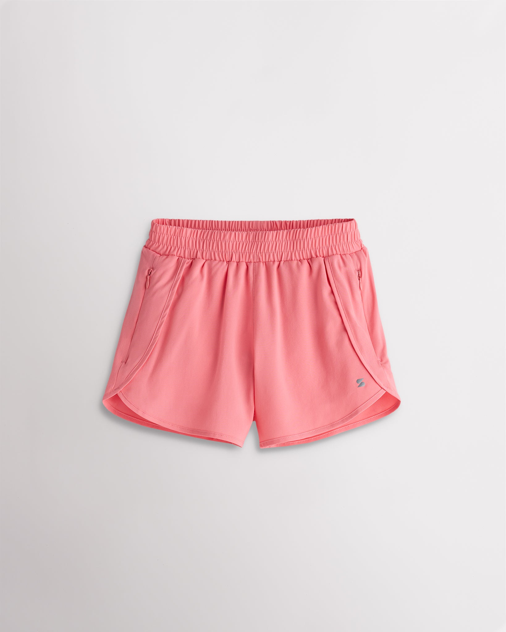 Girls coral athletic running shorts with elastic waistband, curved hem, and lightweight design.
