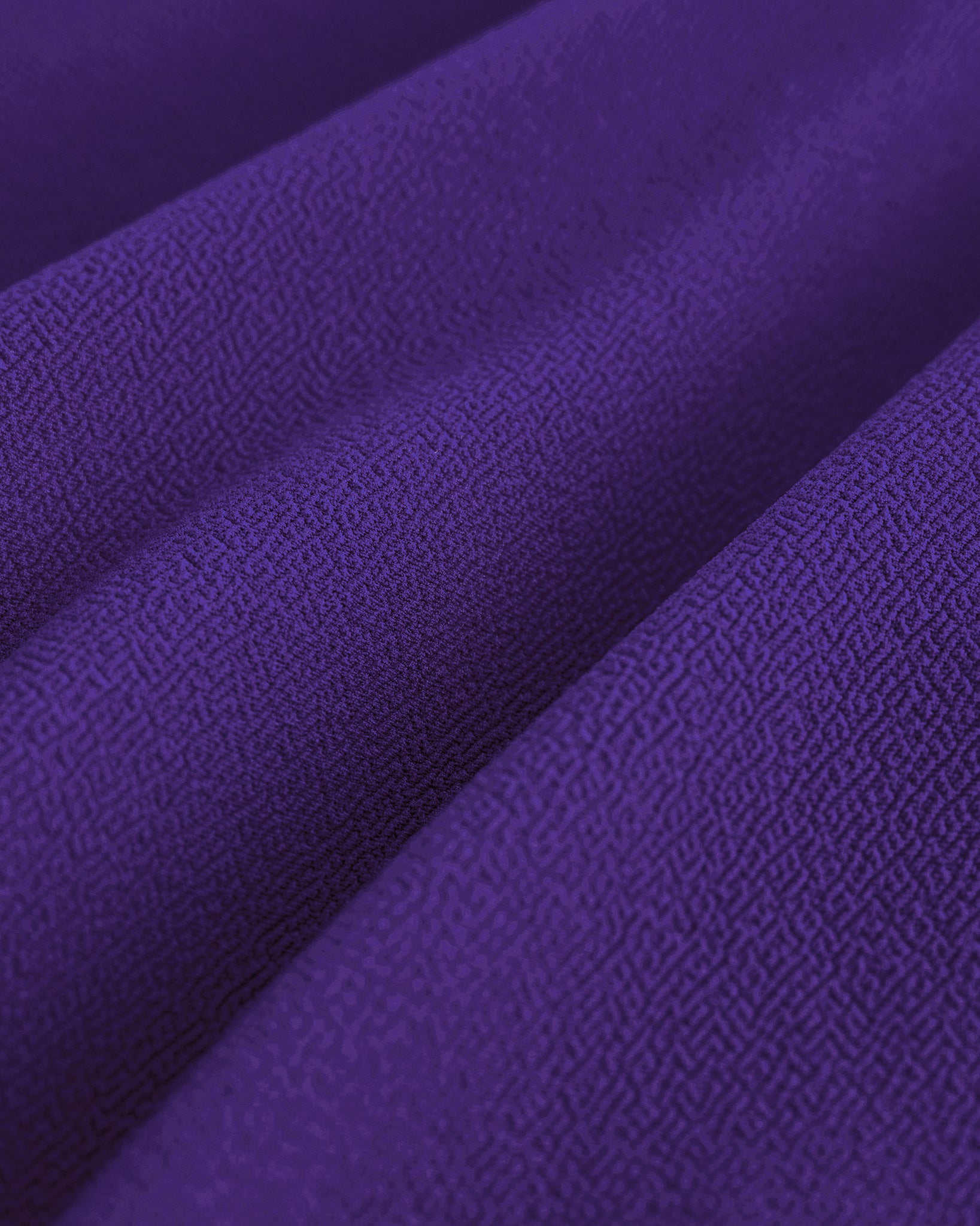 Close-up of purple girls skater skort fabric showing soft stretchy texture and lightweight spandex-blend material.