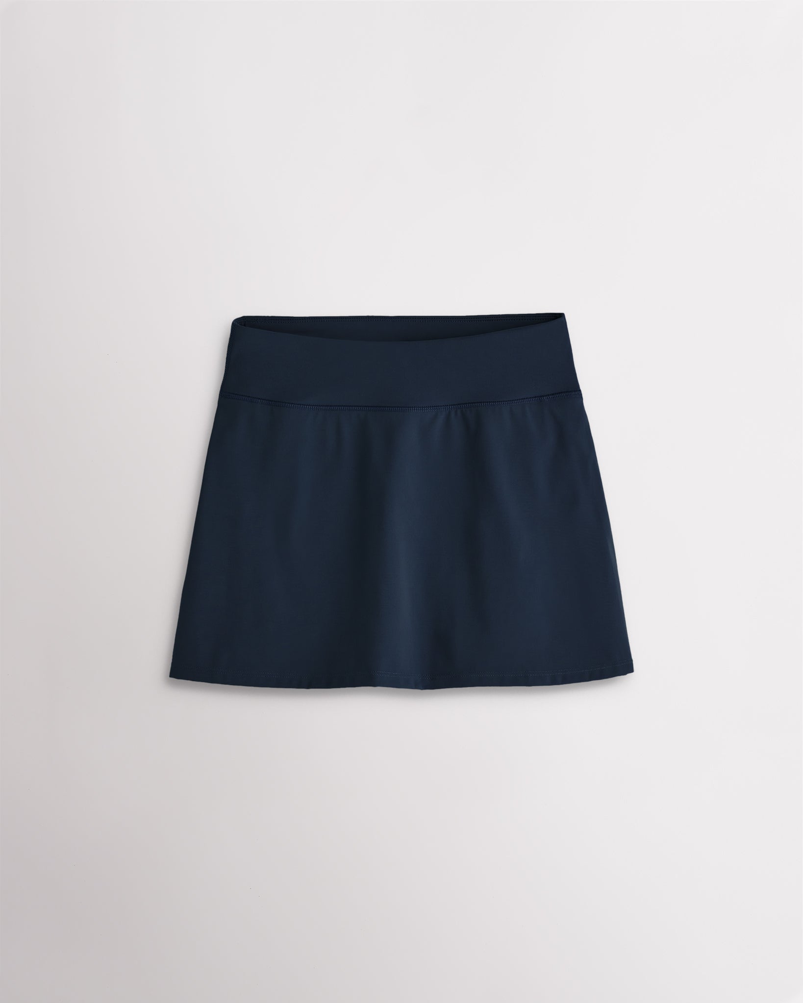 Navy girls ruffle tennis skirt with elastic waistband and smooth stretch fabric for active play