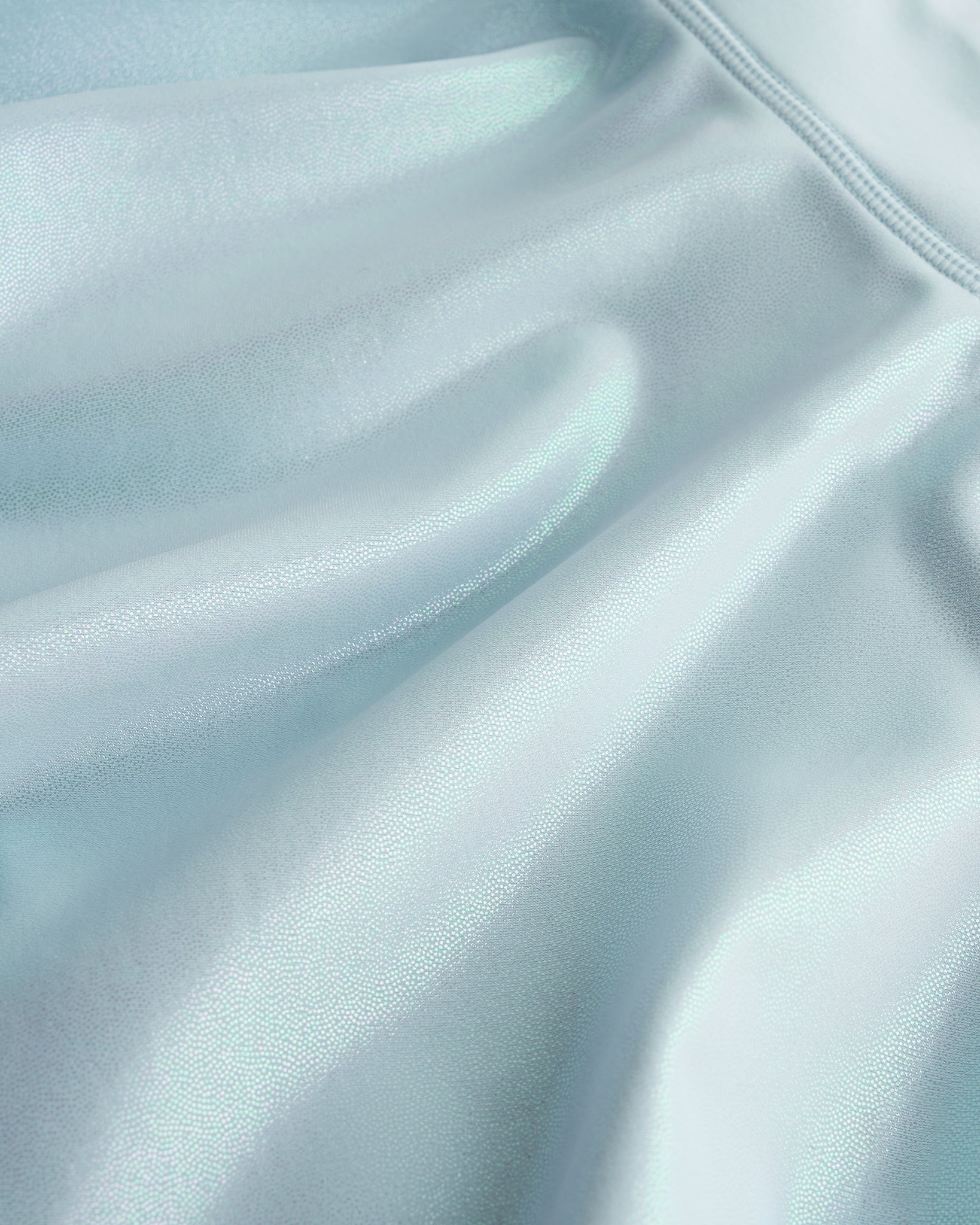 Close-up of light blue Stelle girls shimmer skort showing iridescent fabric texture and smooth seam detail