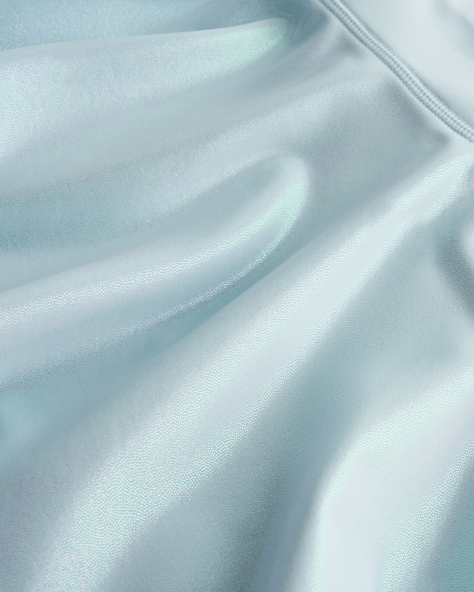 Close-up of light blue Stelle girls shimmer skort showing iridescent fabric texture and smooth seam detail