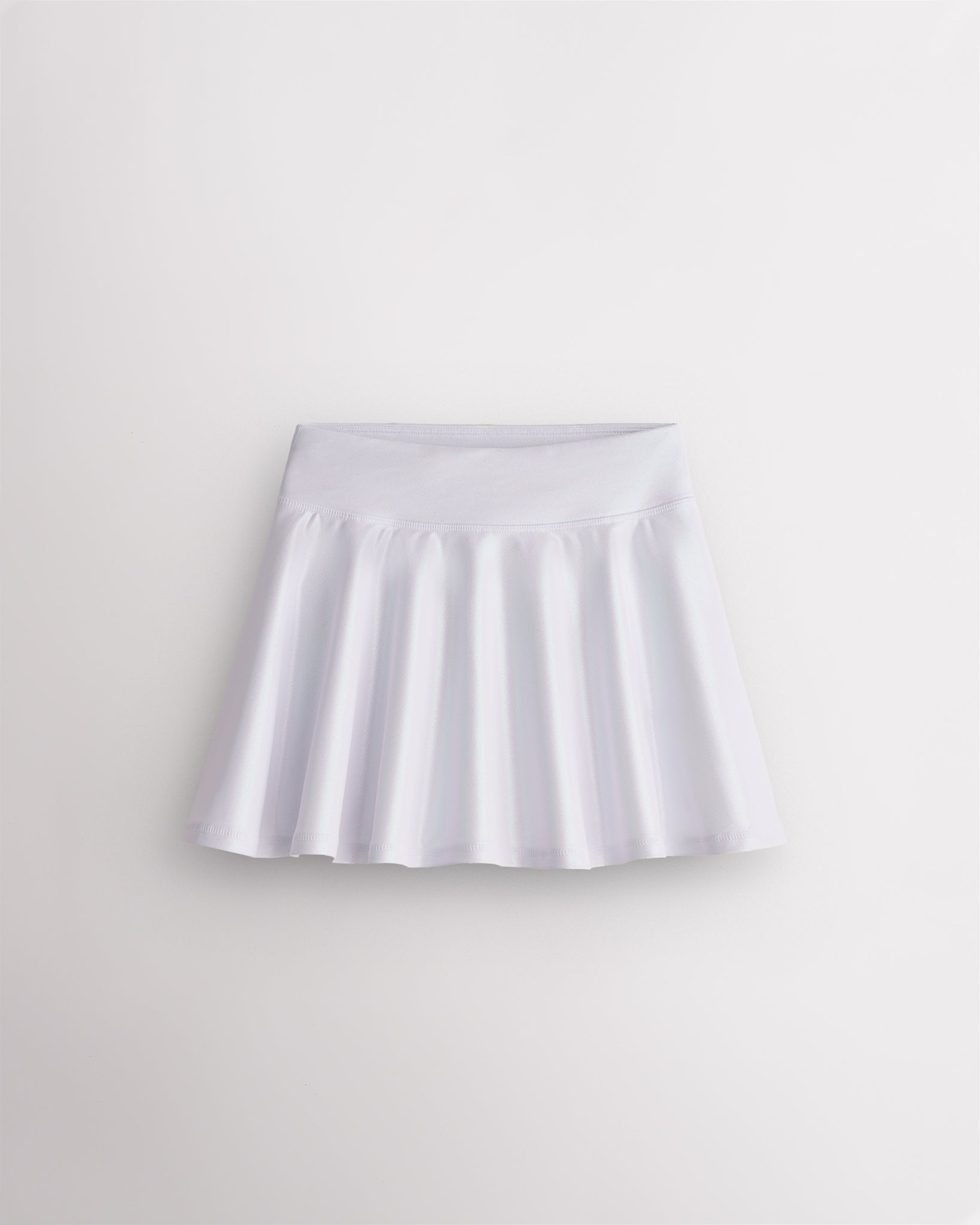 White Stelle girls shimmer skort with high-waisted fit and flared skirt design on white background