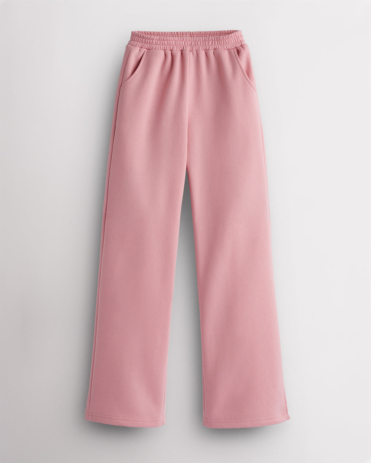 Pink kids fleece sweatpants laid flat with elastic waistband, roomy side pockets, straight-leg fit, and soft fleece lining.