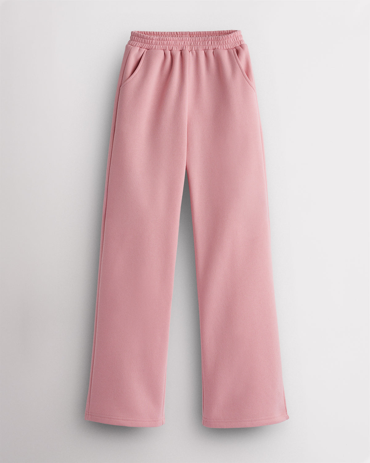 Pink kids fleece sweatpants laid flat with elastic waistband, roomy side pockets, straight-leg fit, and soft fleece lining.