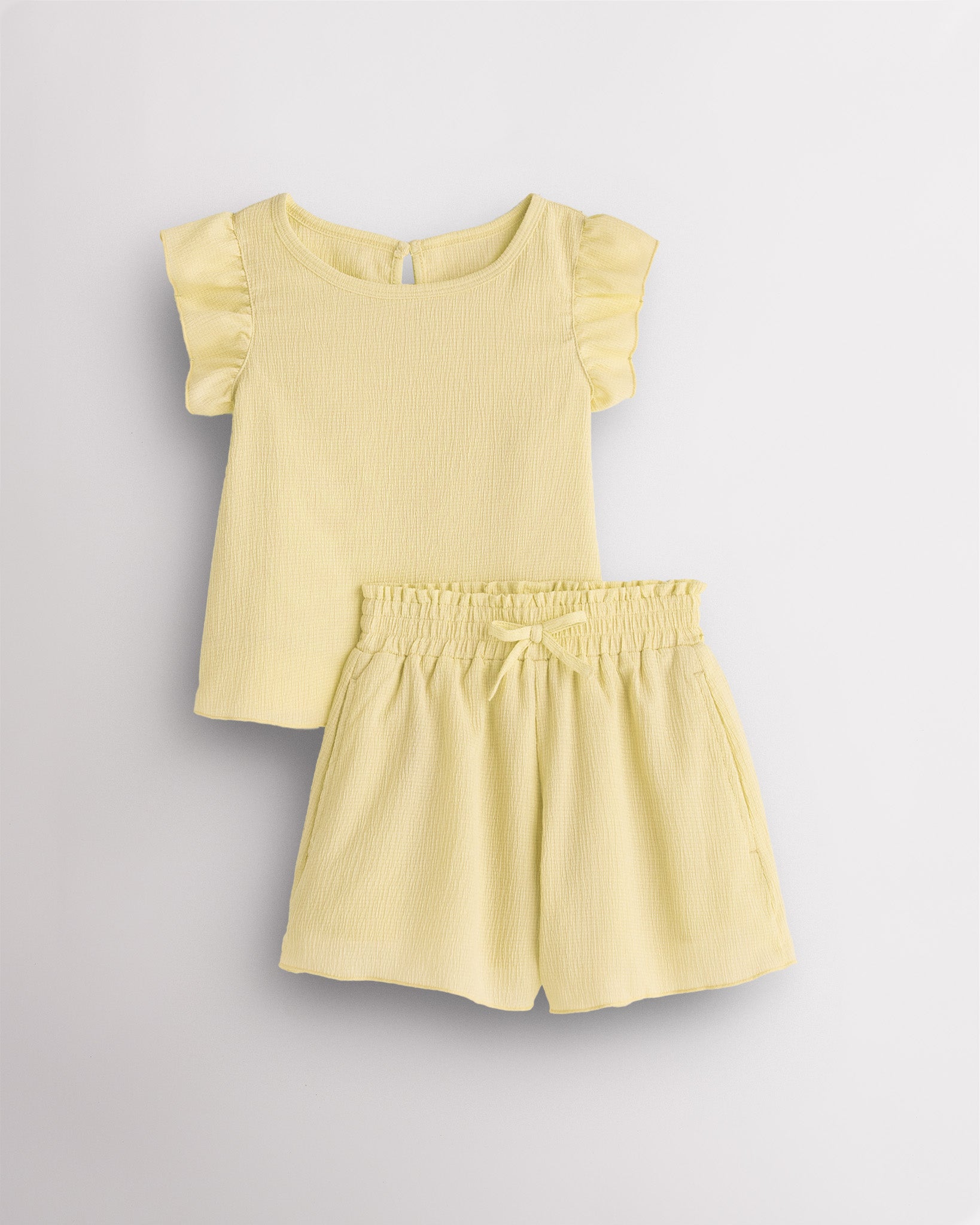 Girls lemon butter flutter sleeve summer outfit set with textured top, button-back detail, and matching elastic waist shorts with bow.