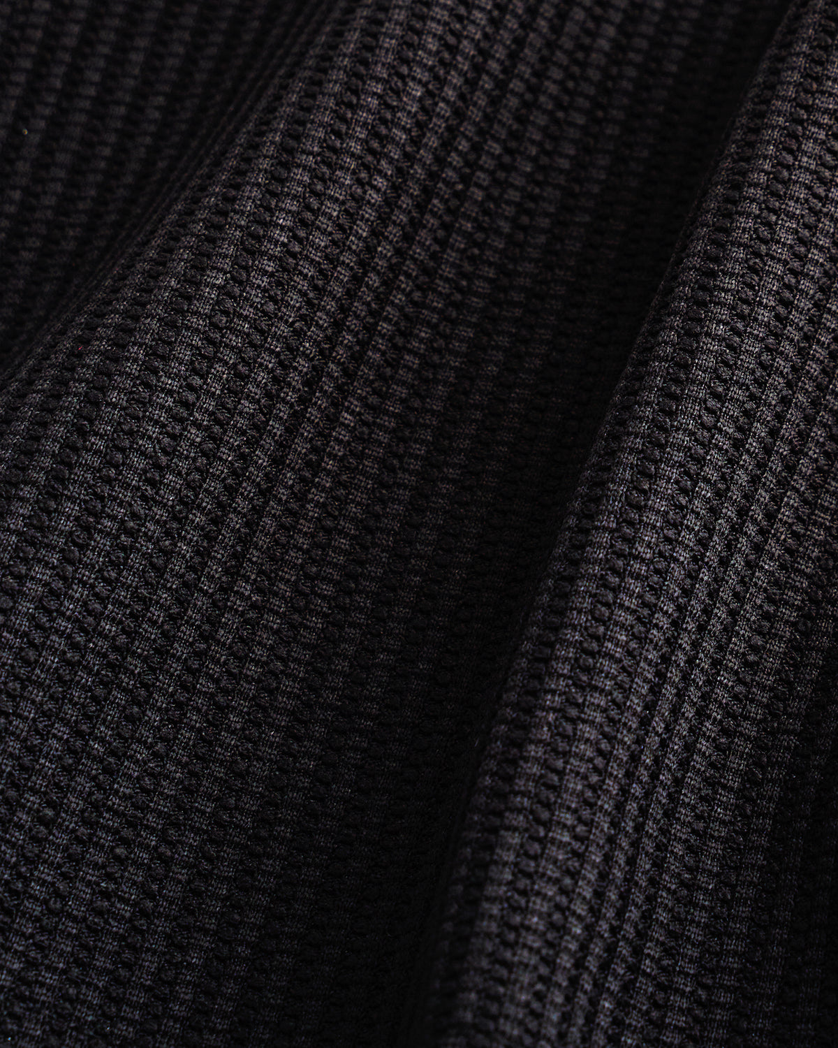 Close-up of the black waffle knit texture on the Stelle kids lounge set.