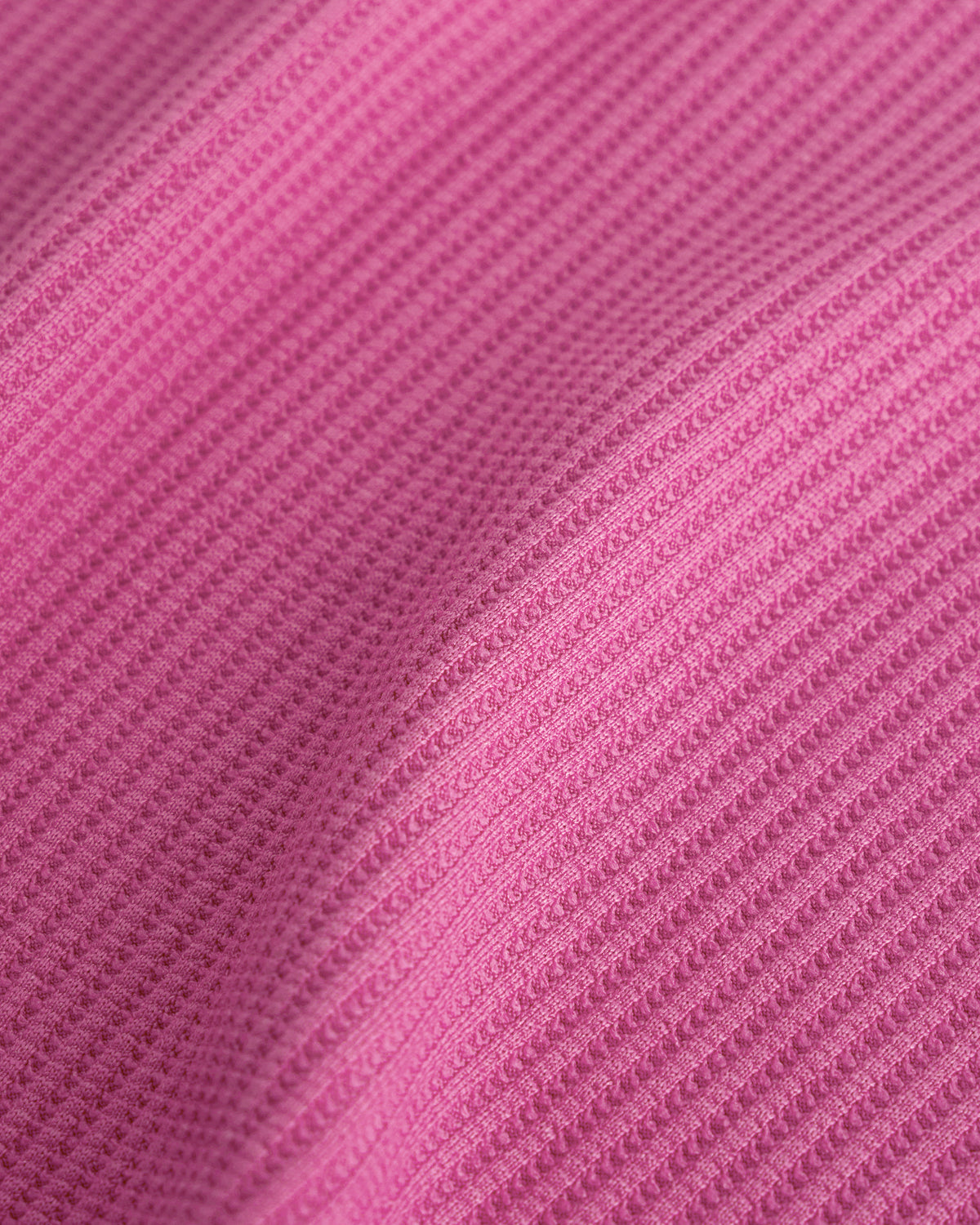 Close-up of the Dreamhouse Pink waffle knit texture on the Stelle kids lounge set.