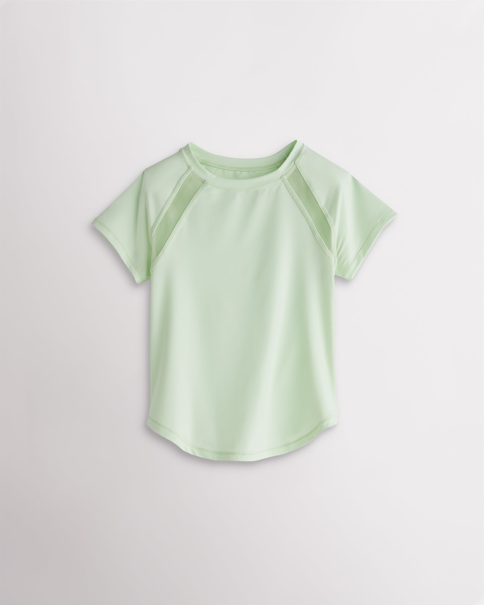 Kids pastel green athletic t-shirt with mesh paneling and raglan sleeves, short sleeve breathable kids sports tee.