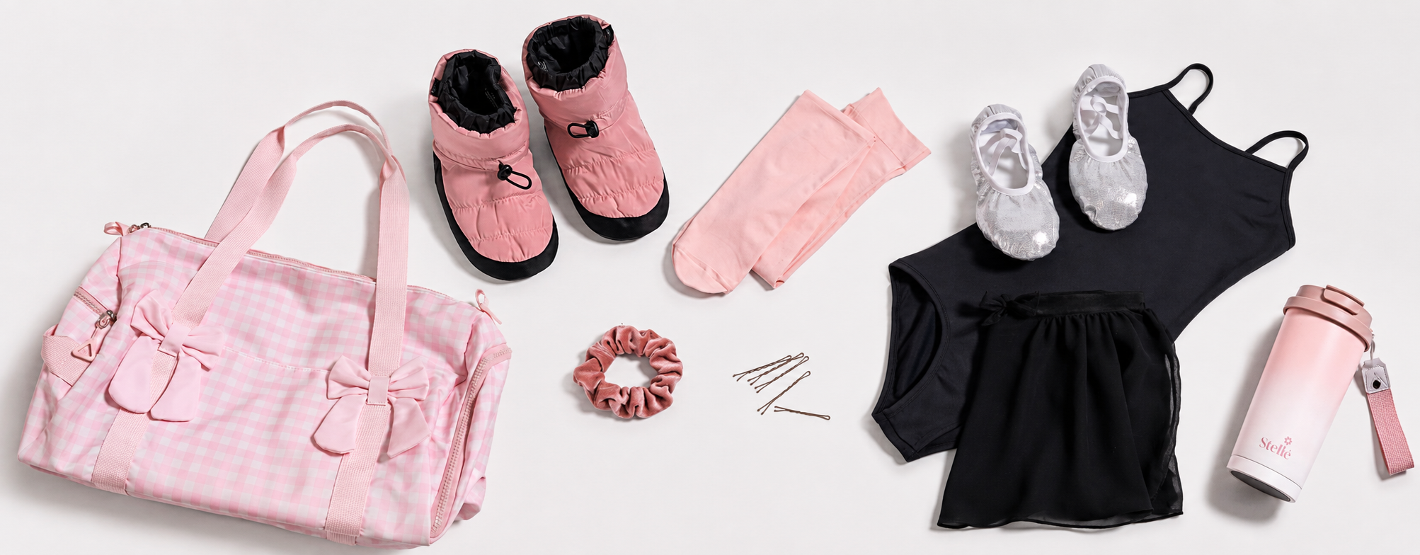 Pink Stelle dance bag flat lay with ballet shoes, black leotard, dance skirt, tights, warm-up booties, scrunchie, hair pins, and water bottle.