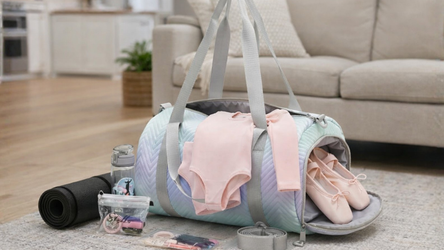A duffle bag with dance leotard, ballet shoes, and hair accessories.