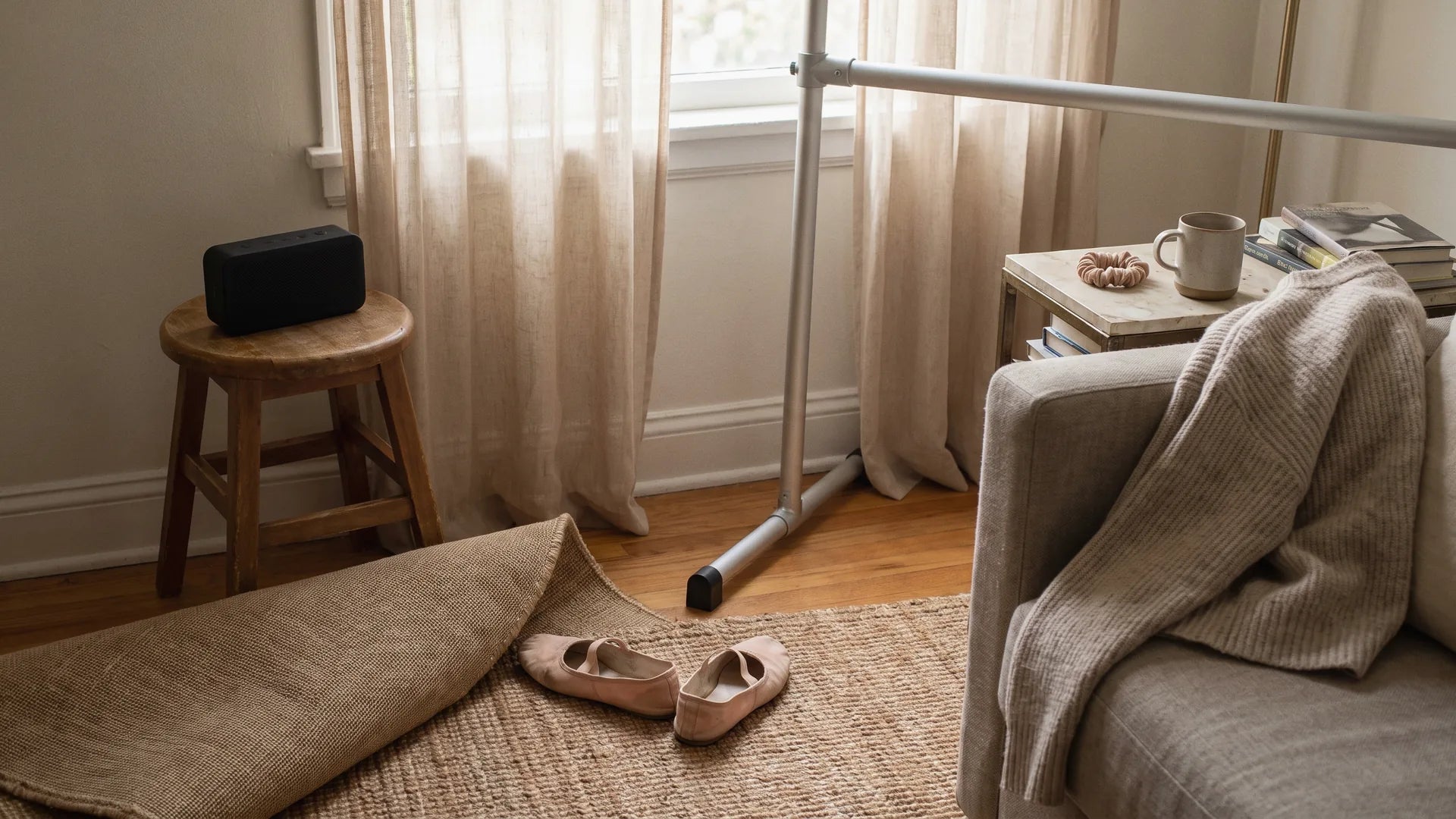 Home ballet practice corner with a portable speaker, ballet slippers, and a small practice barre ready for children's ballet music