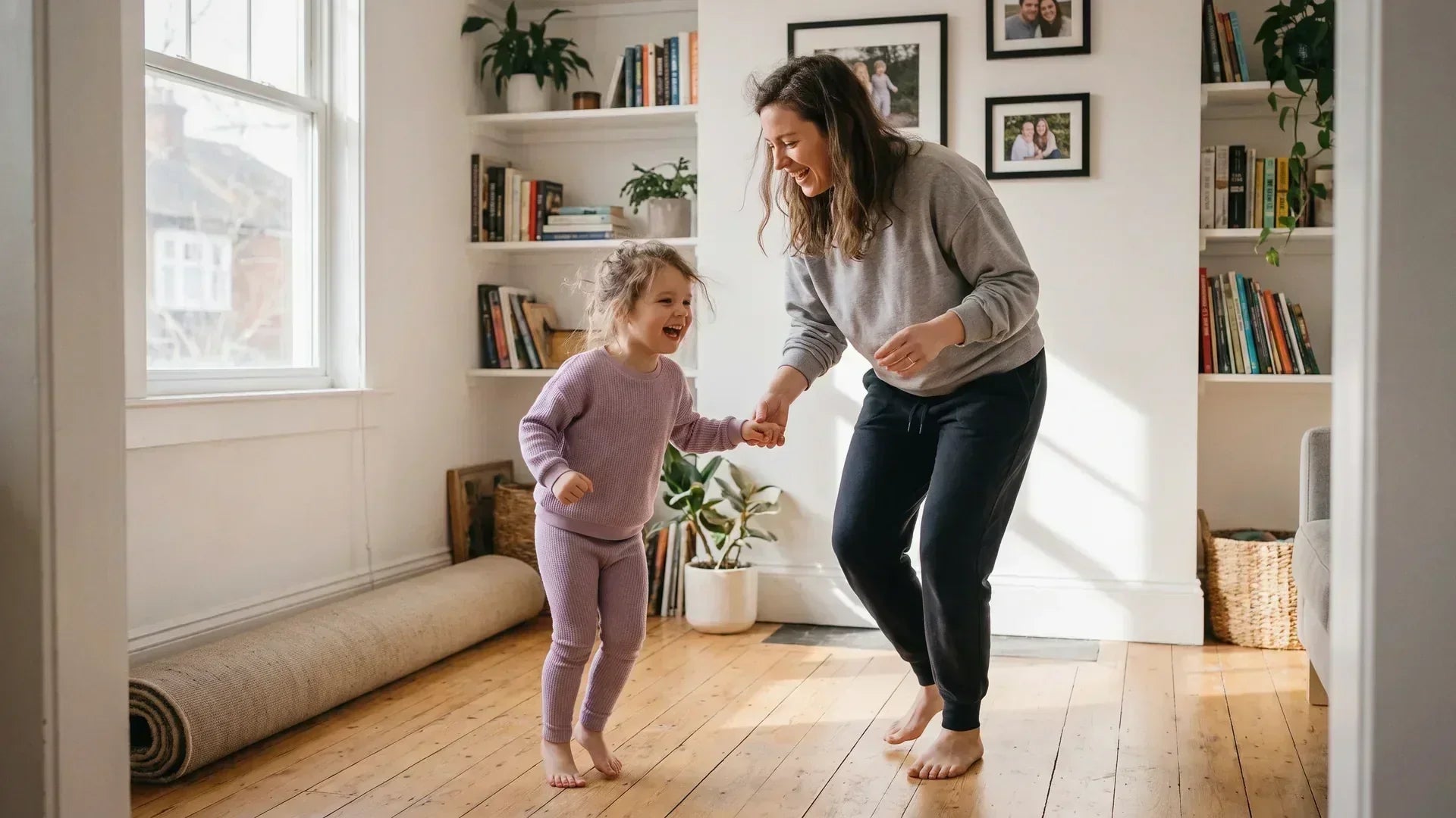 Parent and child learning how to dance together at home