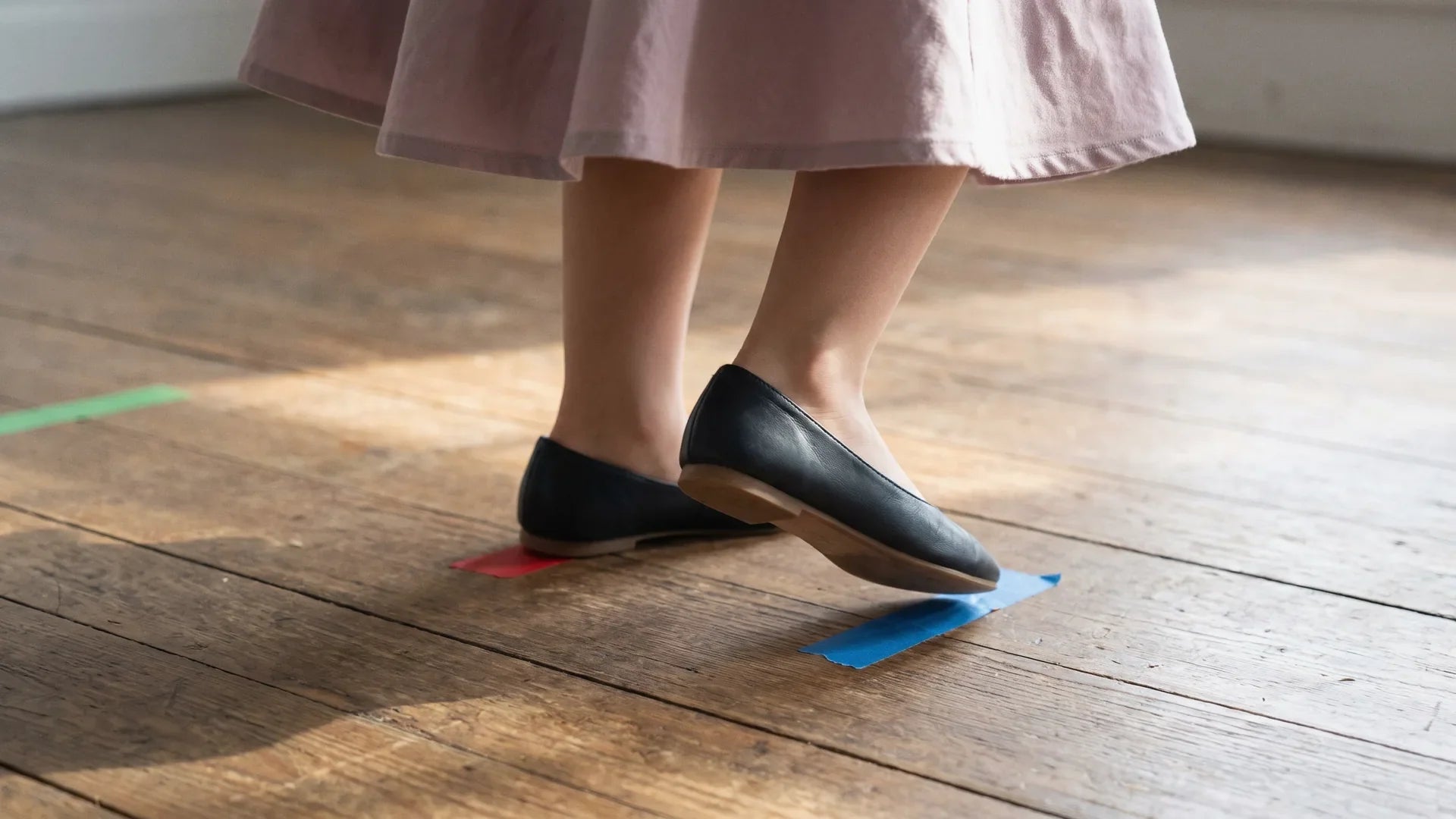 Child's feet in smooth-soled flat shoes stepping through the rock step and triple step of the basic East Coast swing