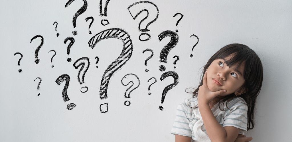 Child with thoughtful expression surrounded by question marks on a light background